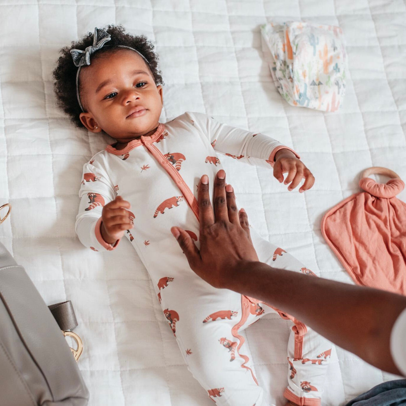 baby laying in a milk bath with a kyte baby sea sponge on top of him