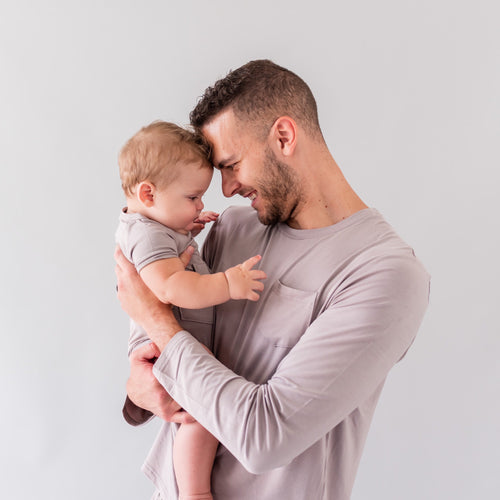 dad wearing kyte baby jogger set and holding his baby