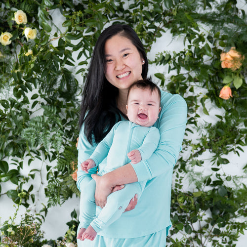 Mom and infant wearing Kyte Baby pajamas in color Robin