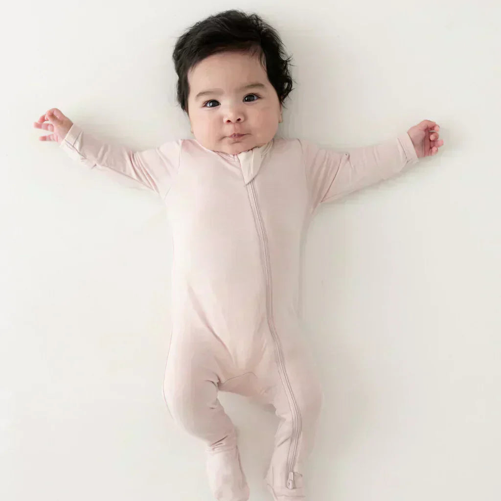 Baby in blush pink zipper footie pajamas