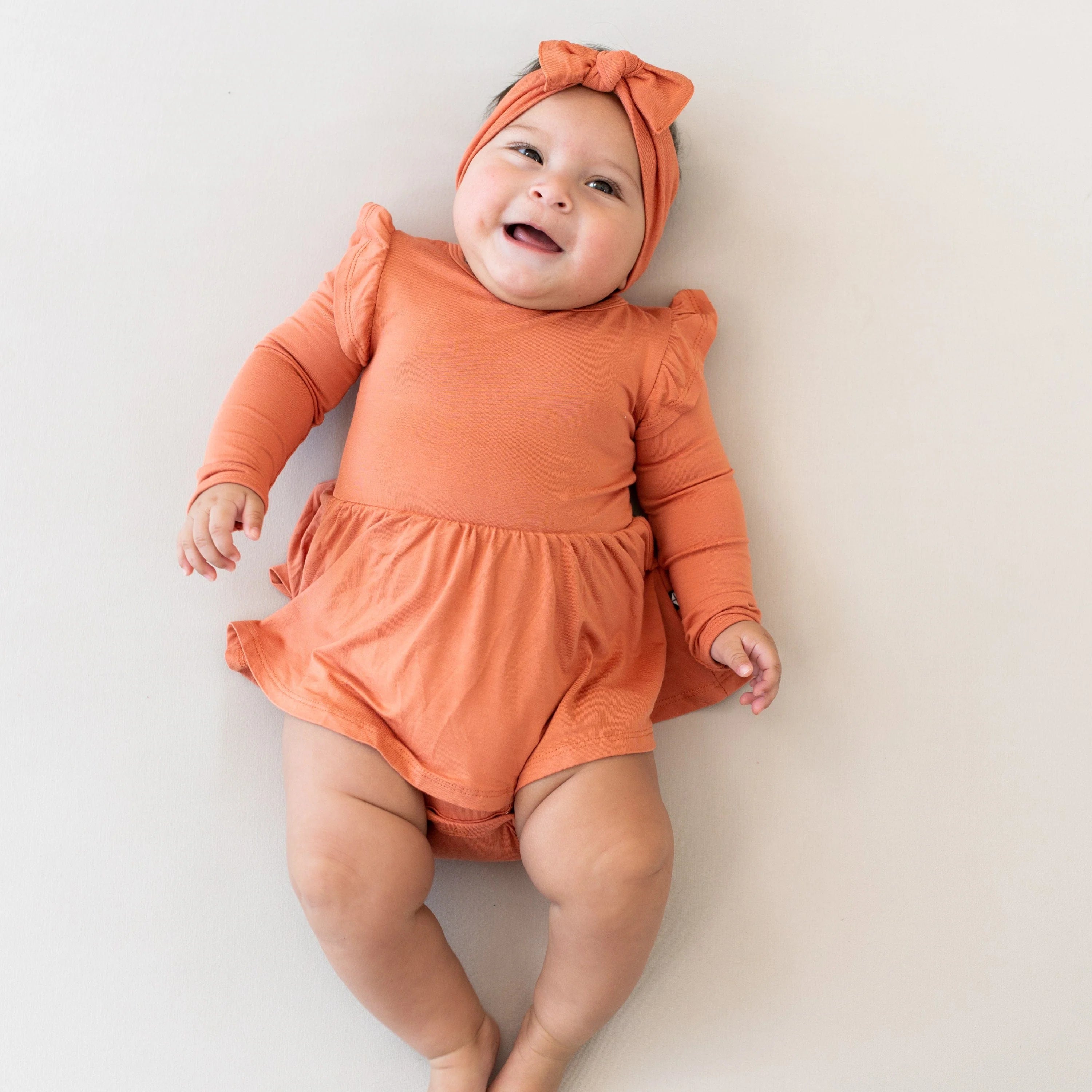 baby laying in the crib in a kyte baby sleep b ag