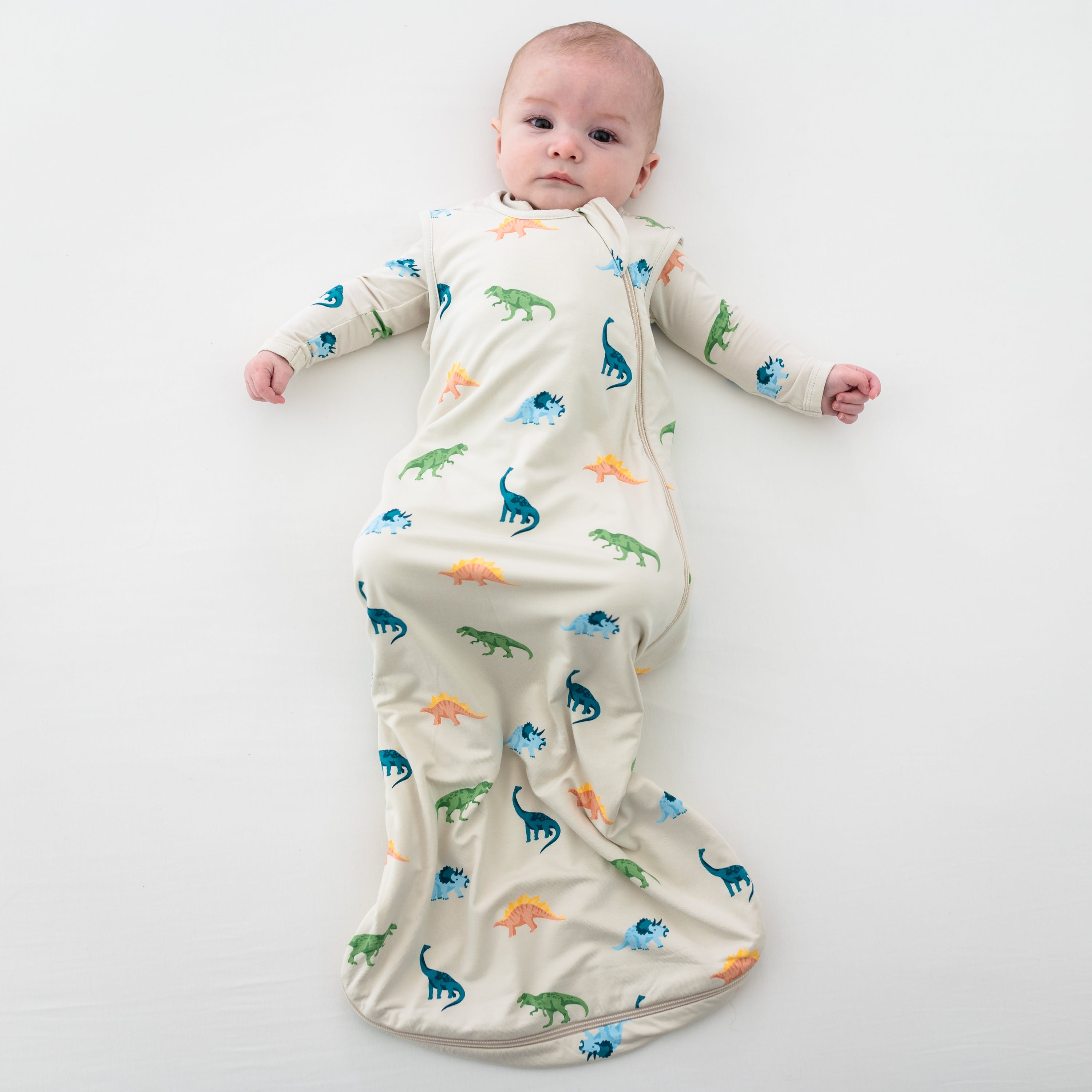 Infant modeling Kyte Baby 0.5 TOG Sleep Bag in Ecru Roar