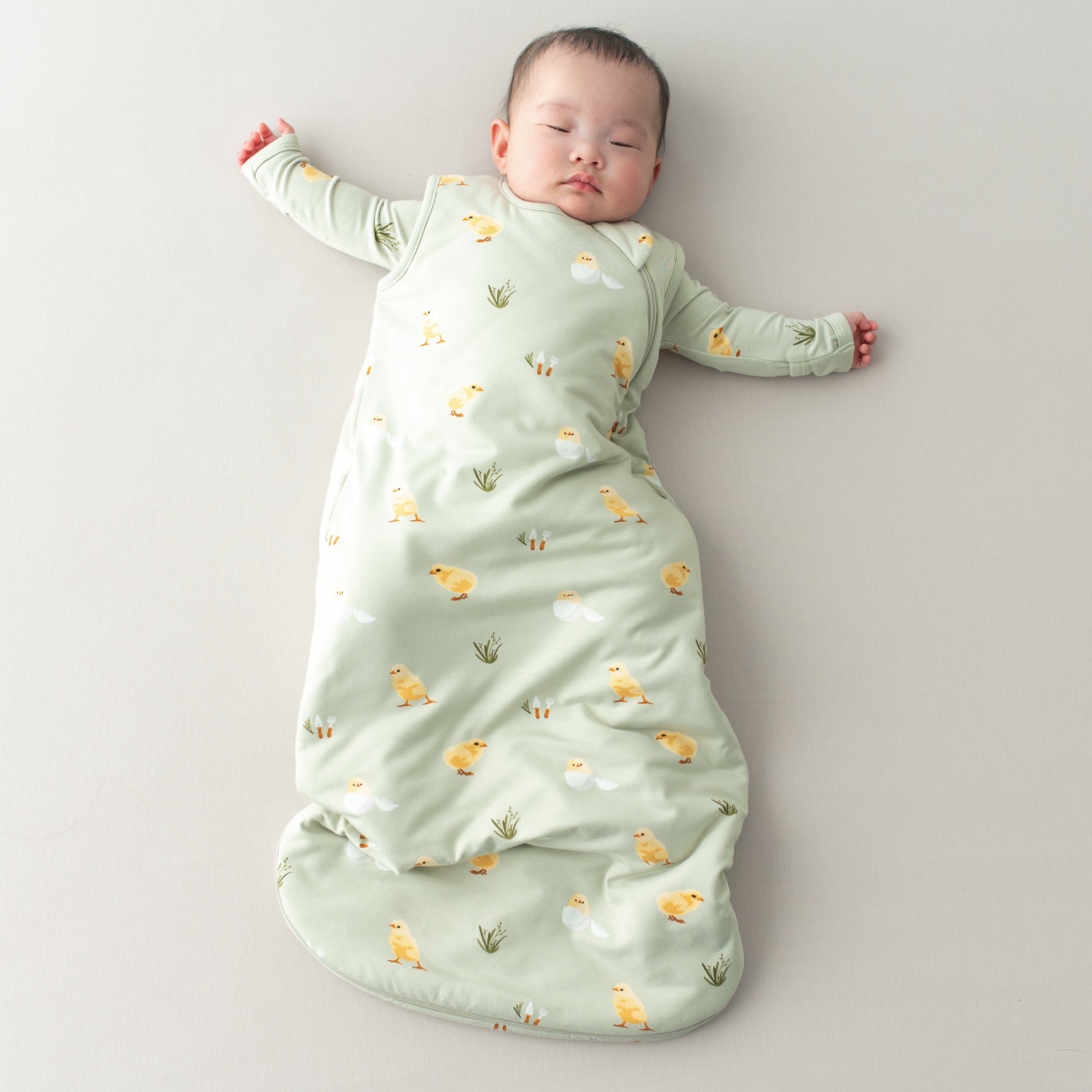 Baby sleeping in TOG 1.0 Aloe Chick Easter Sleep Bag