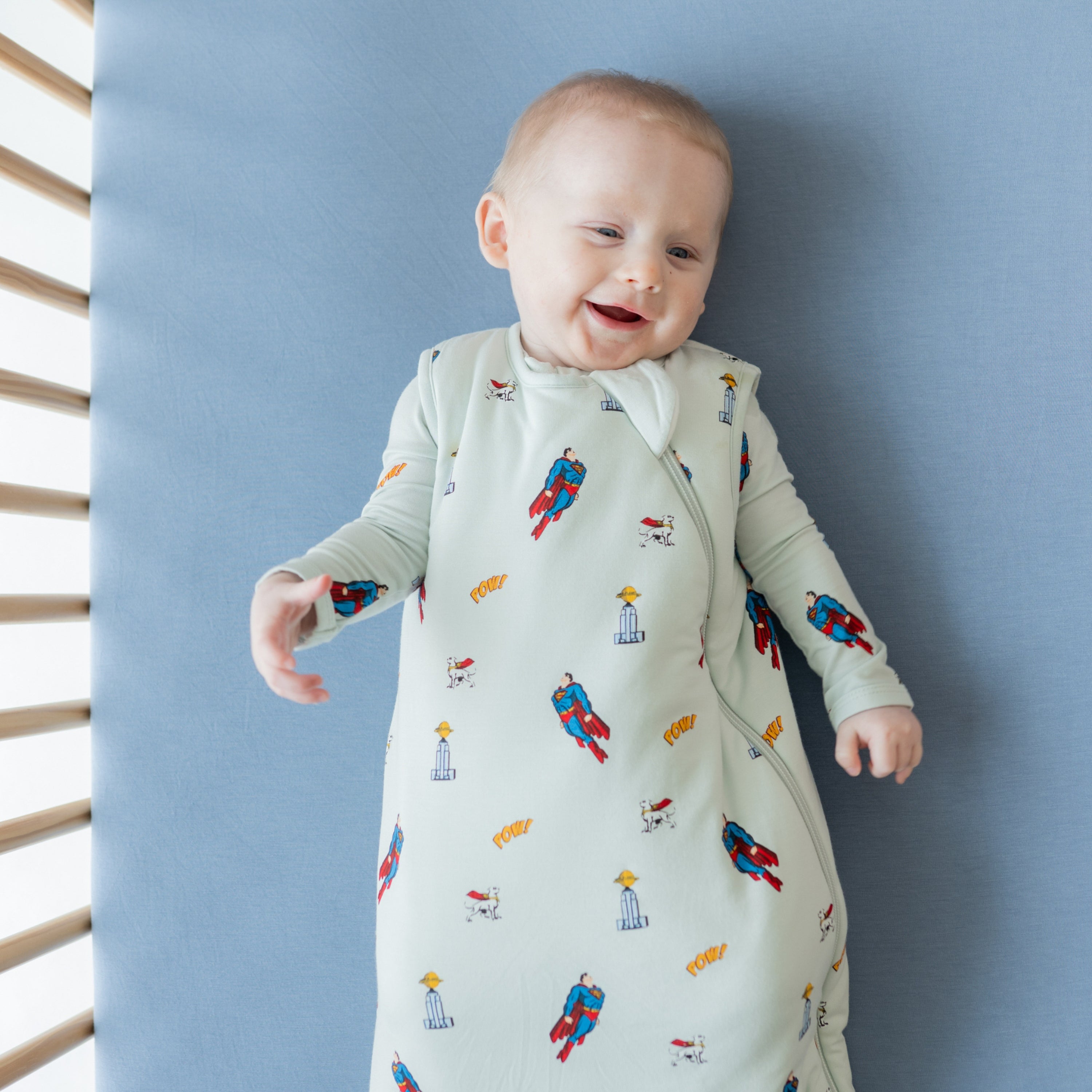 Close up of baby wearing the Sleep Bag in Superman™ 1.0 laying in a crib