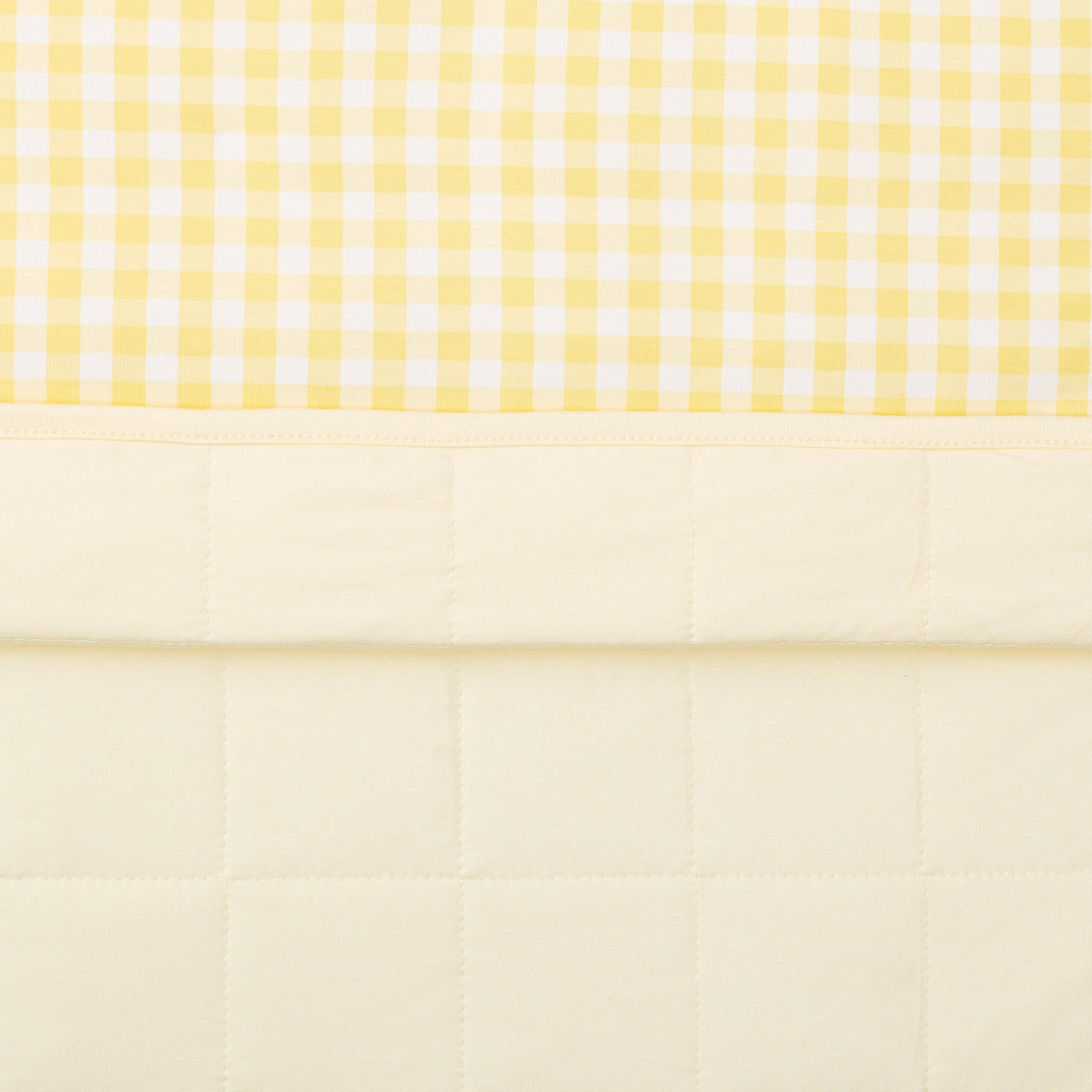 Close up of the quilted backside and smooth printed top layer of the Baby Blanket in Gingham Chamomile