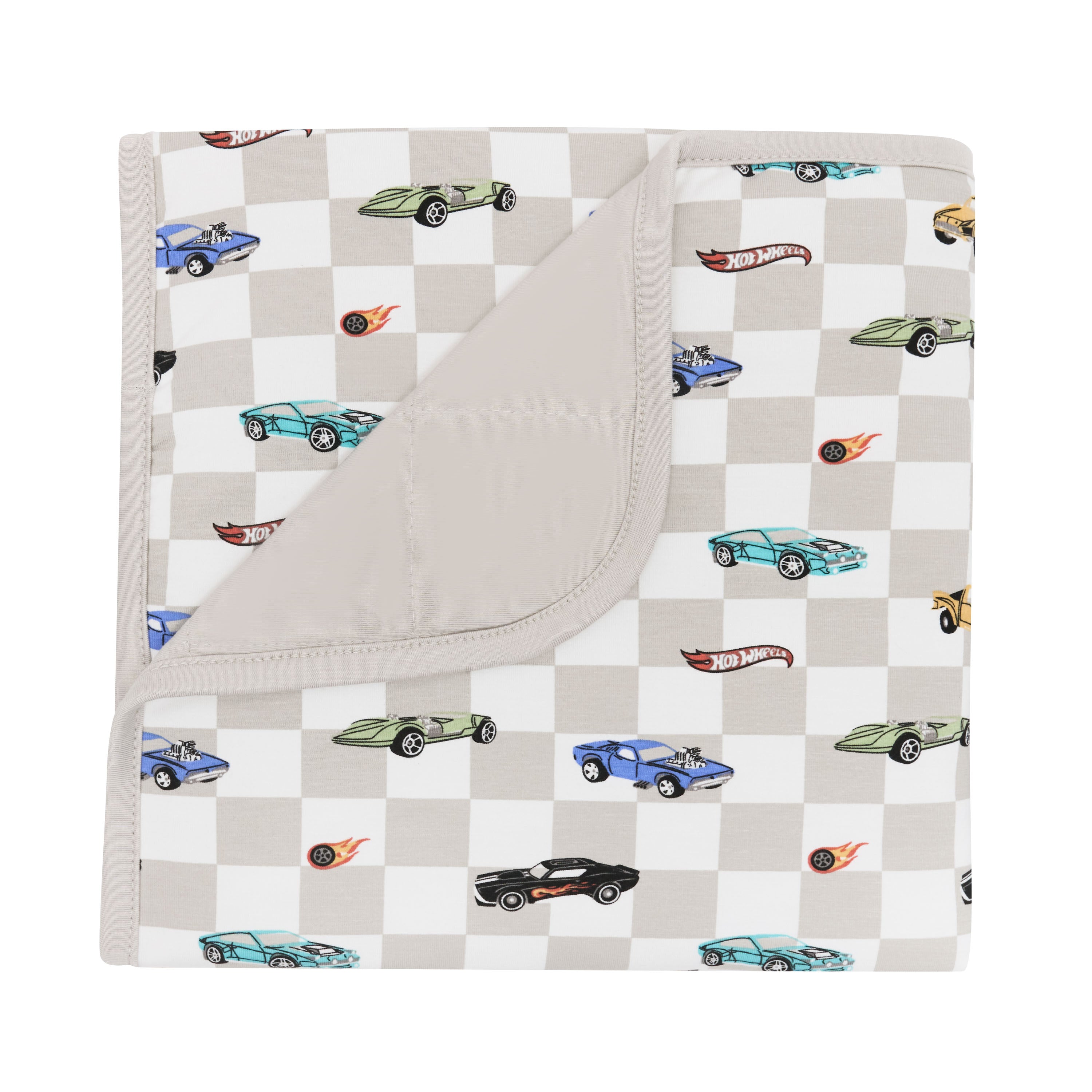 Kyte Baby's Baby Blanket in Fast and Fierce 1.0 with corner flipped down showing Oat backing