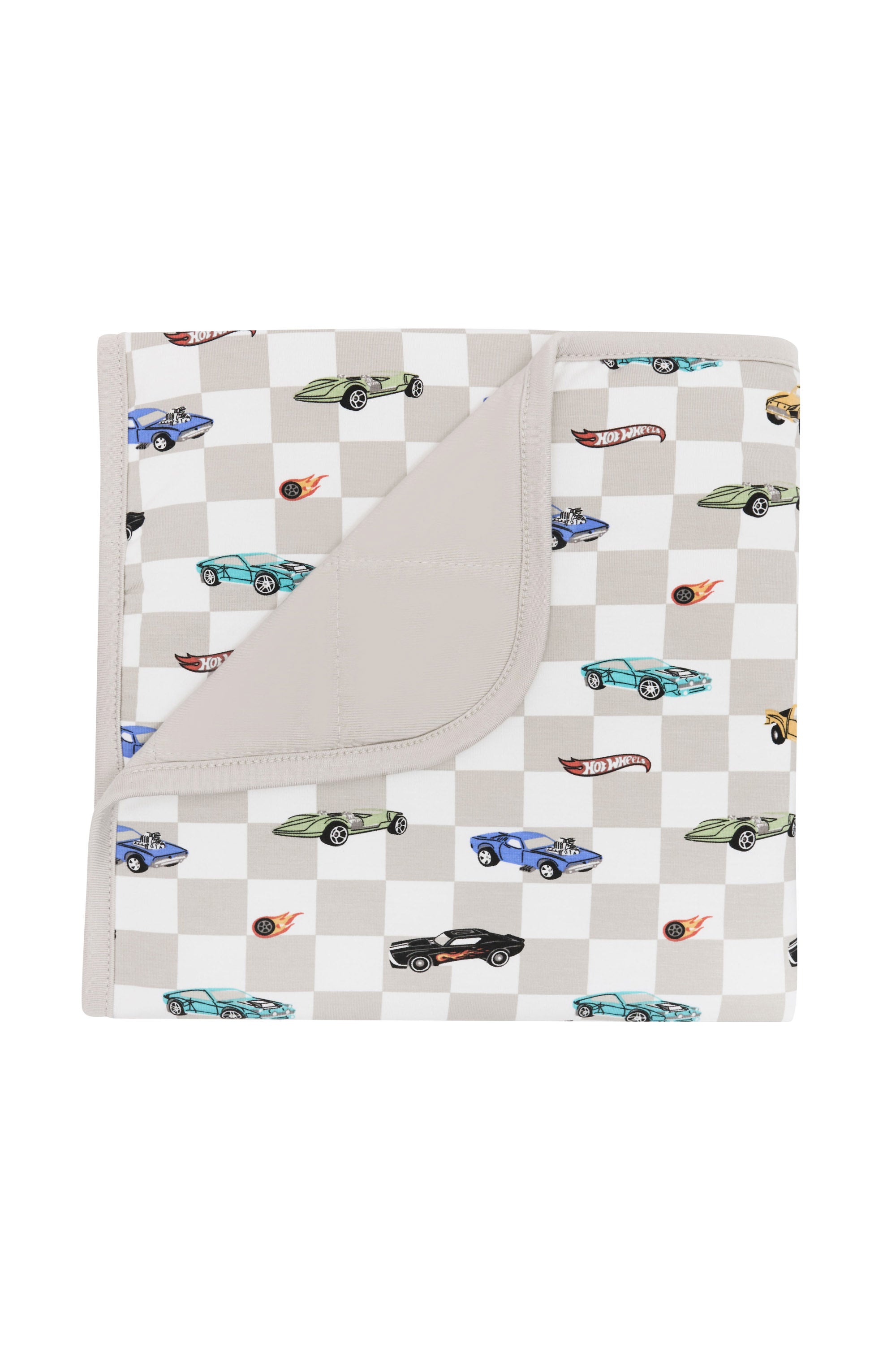 Kyte Baby's Baby Blanket in Fast and Fierce 1.0 with corner flipped down showing Oat backing