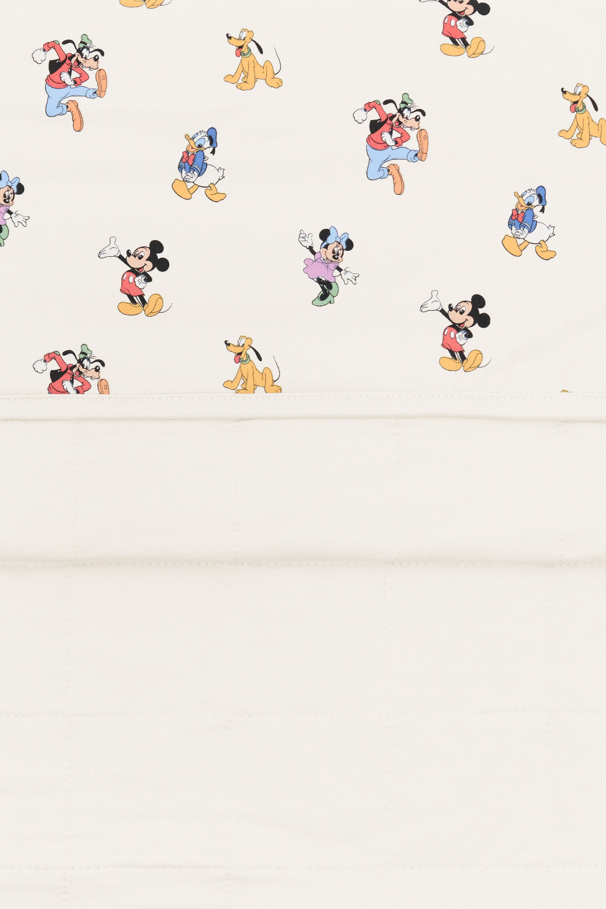 Back side fabric of baby blanket with mickey mouse and friends print on an oat background.