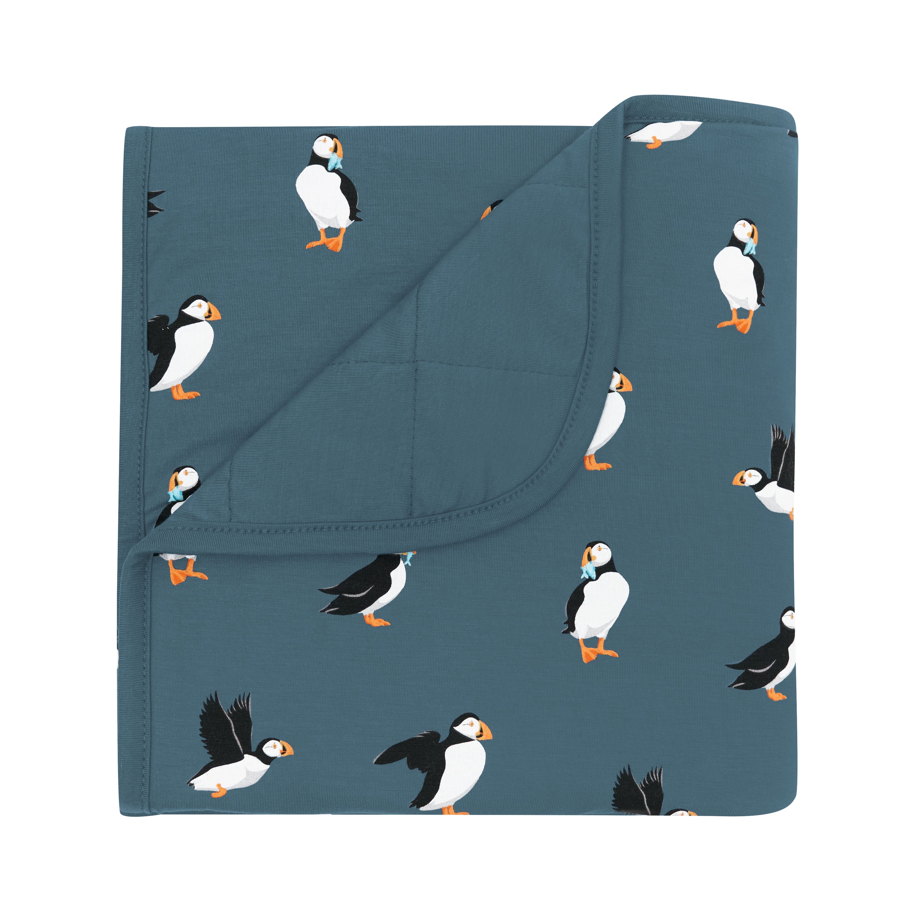 Baby Blanket in Puffin with the corner flipped over showing the Atlantic color backing