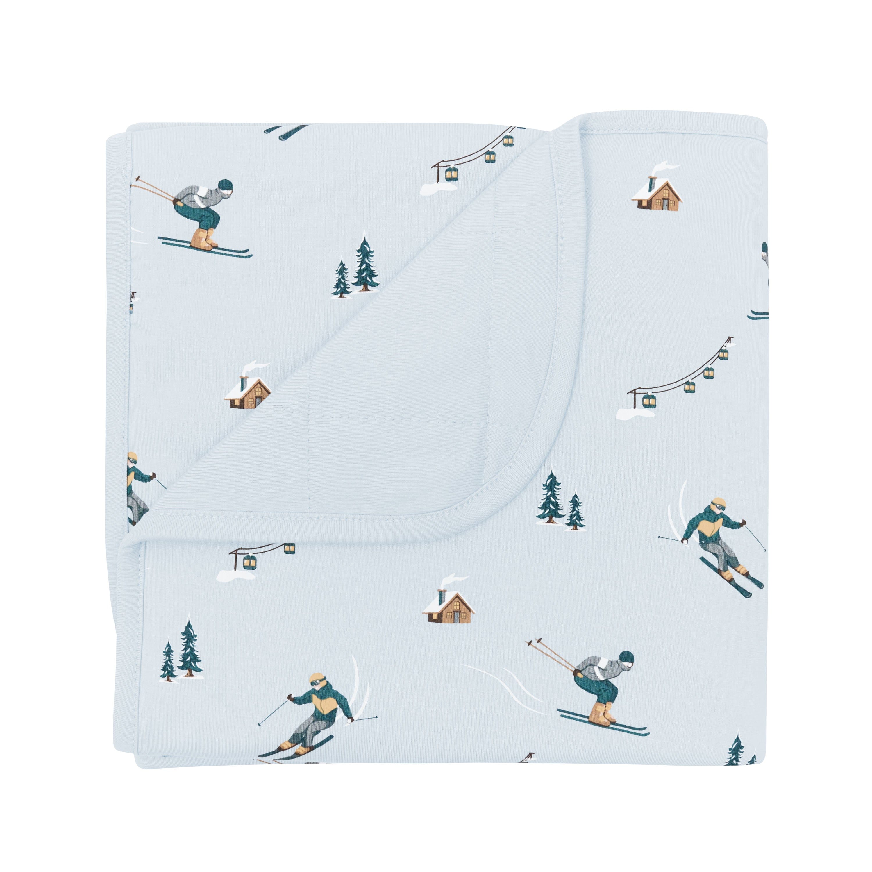 Baby Blanket in Ski with the corner flipped down showing the light blue backing resting on a white surface
