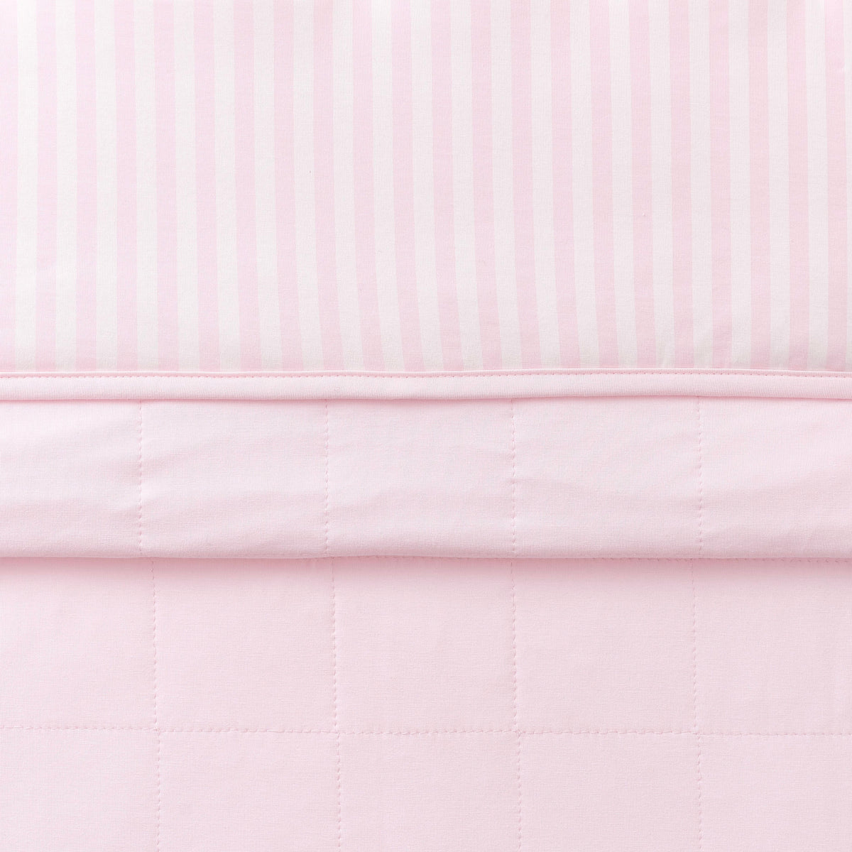 Toddler Blanket in Small Sakura Stripe 1.0 folded showing the quilted detail on the back of the blanket and the print detail on the front