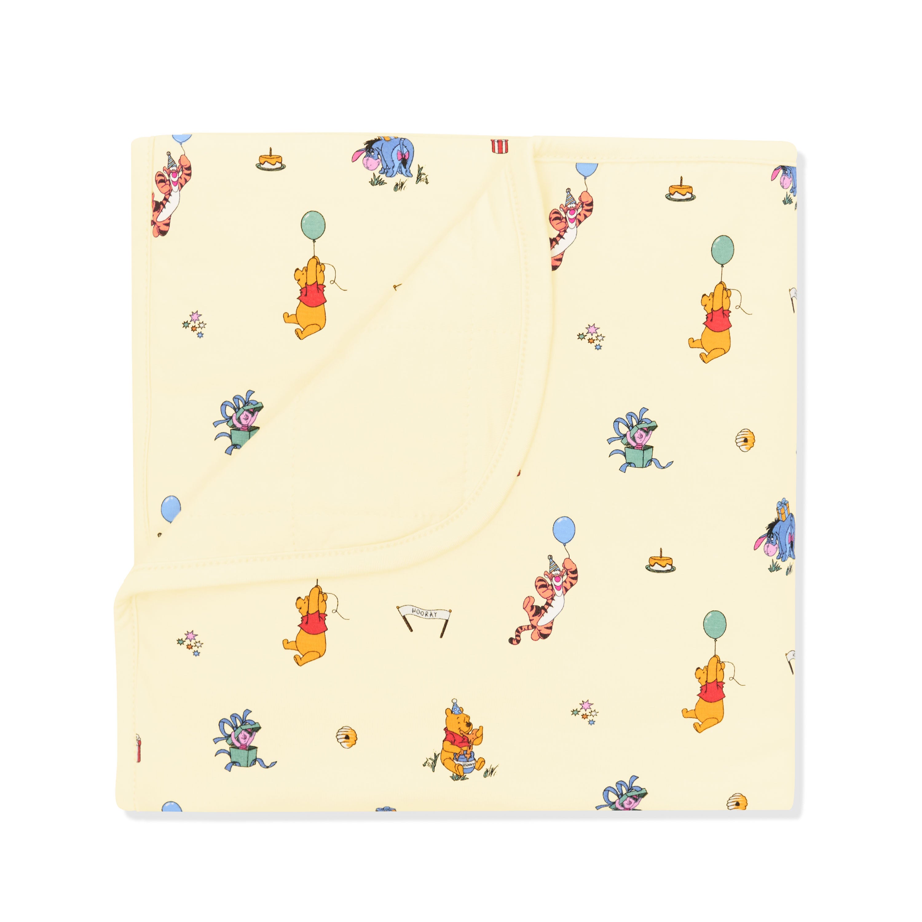 Baby Blanket in Winnie the Pooh Celebration with the corner folded down showing the light yellow backing