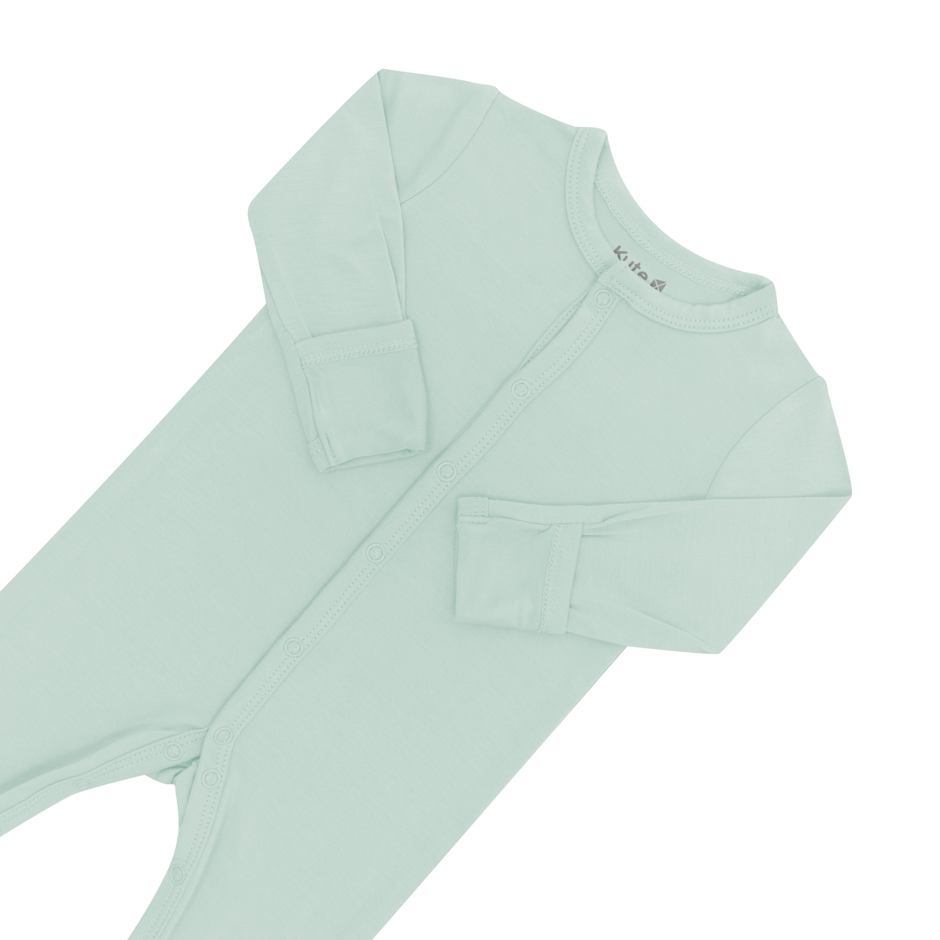 Close up of top portion of Kyte Baby Romper in Sage with arms folded in