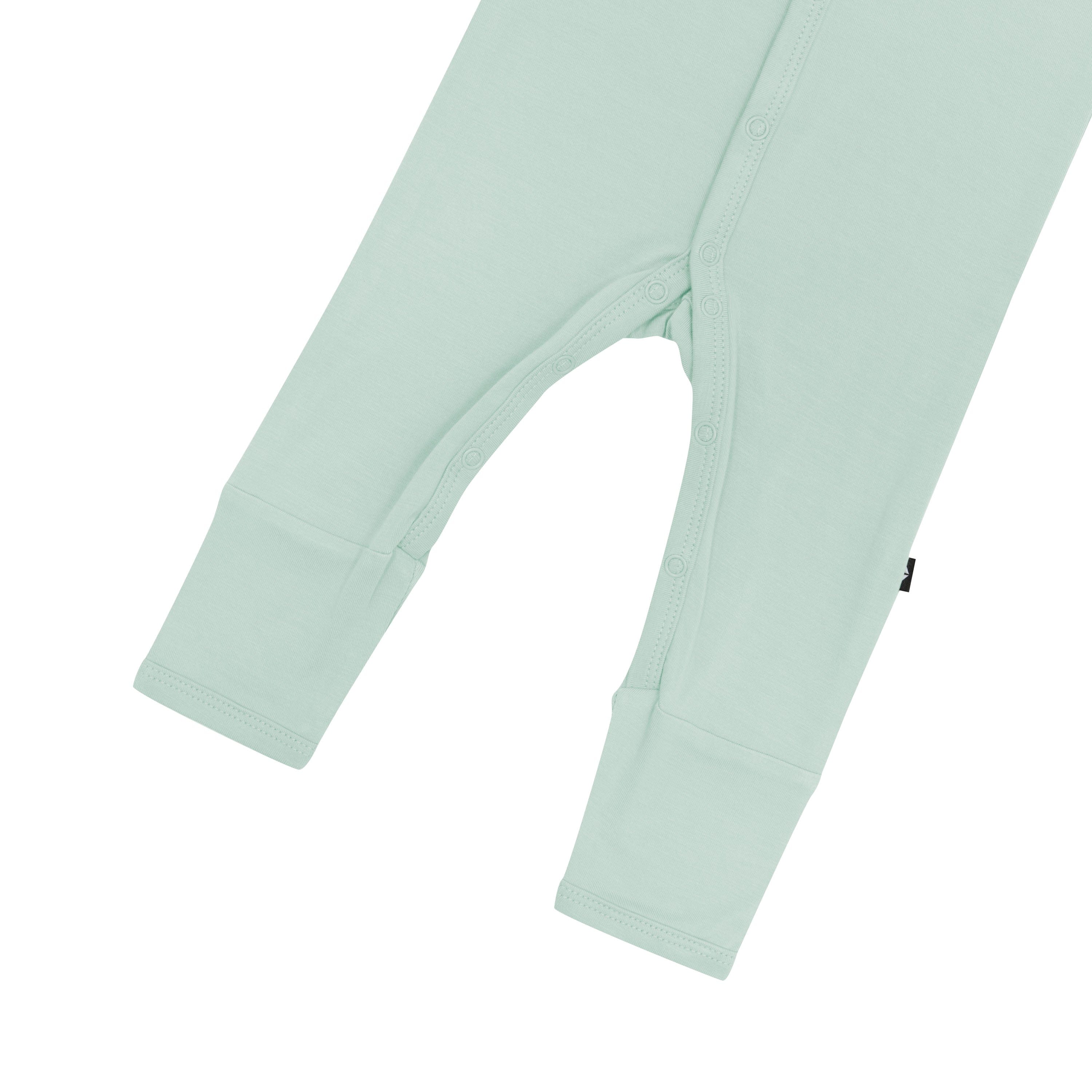 Close up of snaps and legs on Kyte Baby Romper in Sage