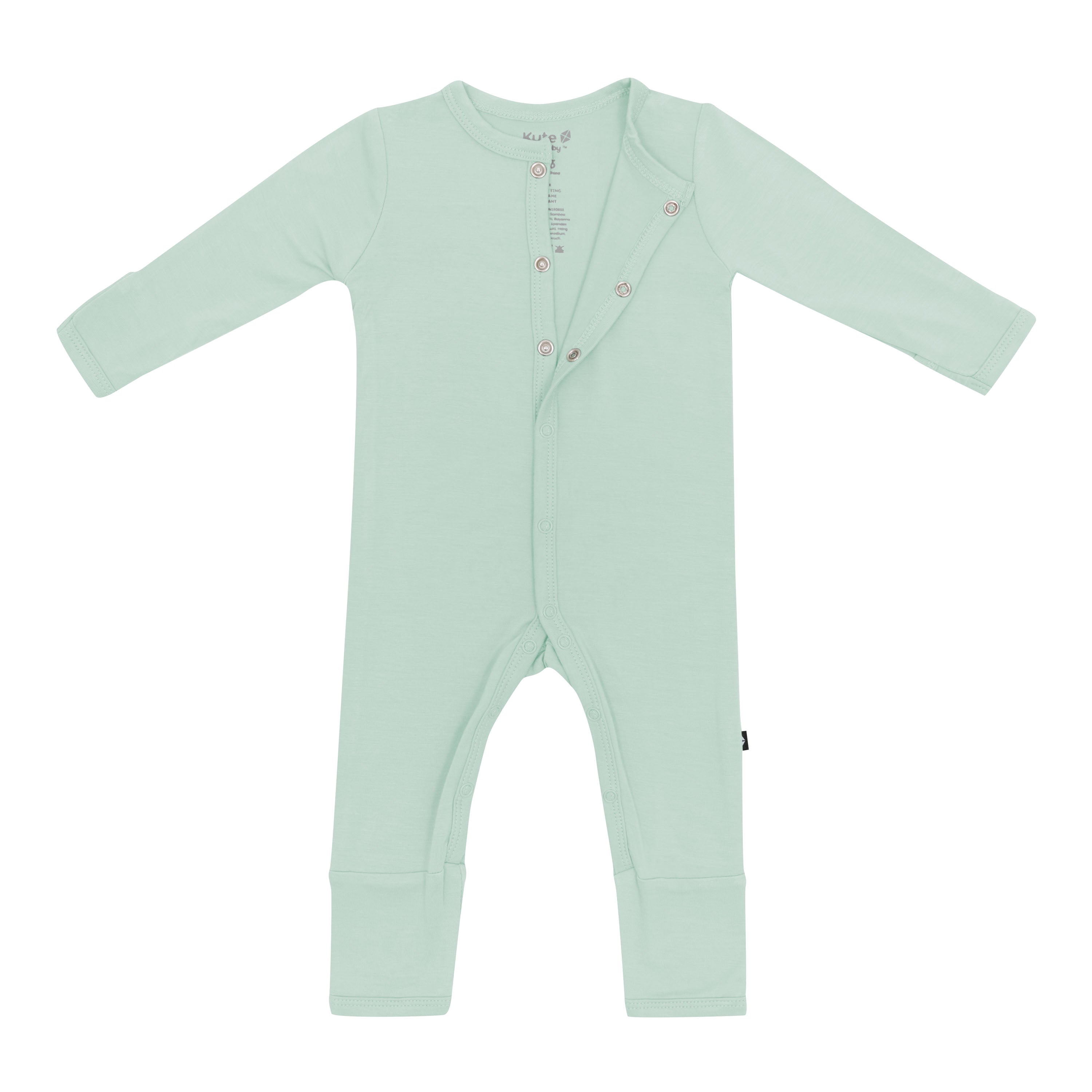 Flat lay of Kyte Baby Romper in Sage with top snaps opened