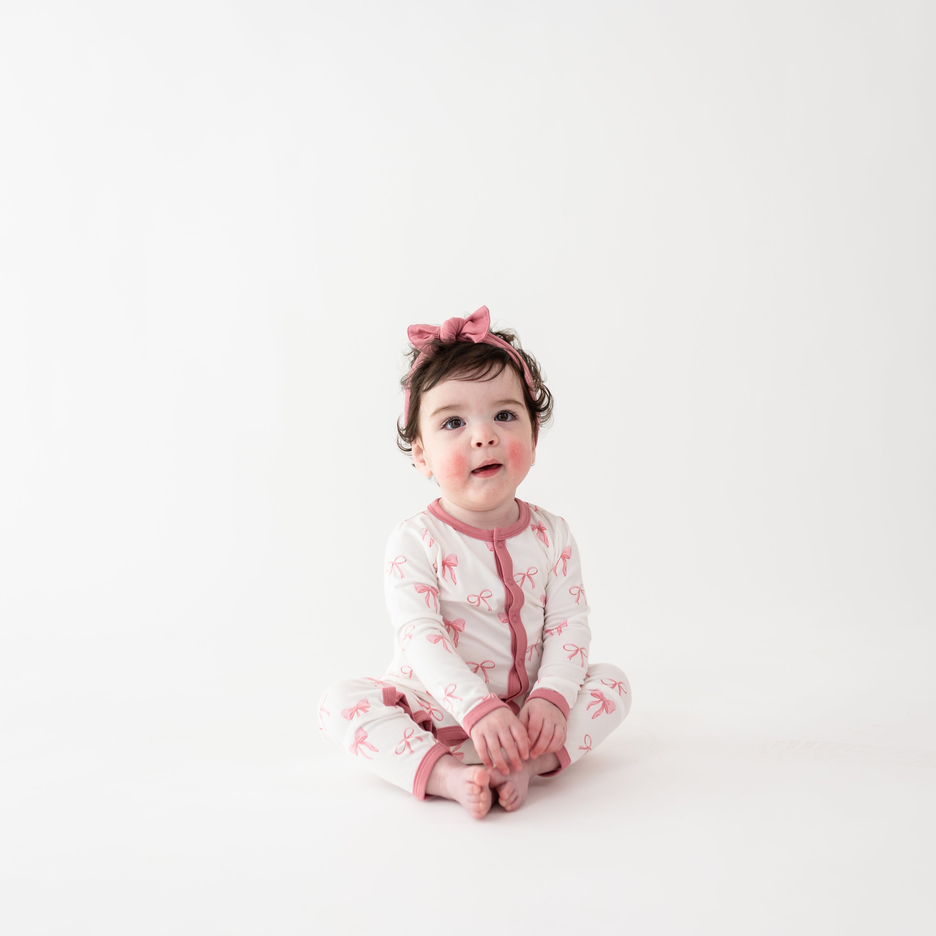Toddler girl wearing Romper in Bow and Apple Blossom bow