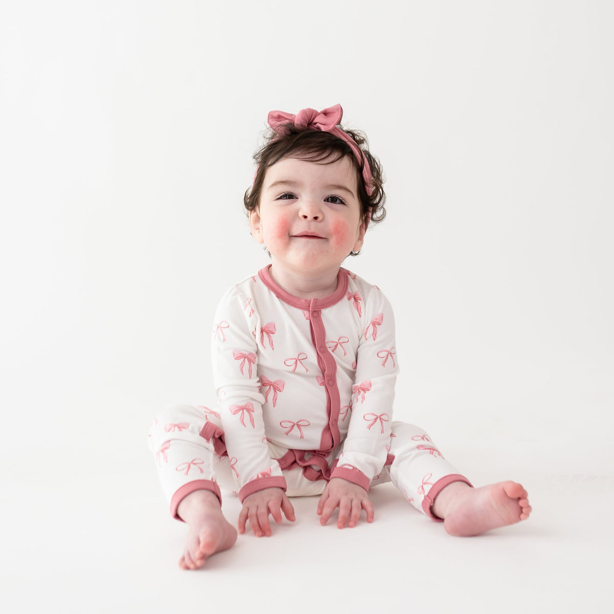Toddler girl wearing Romper in Bow and Apple Blossom bow