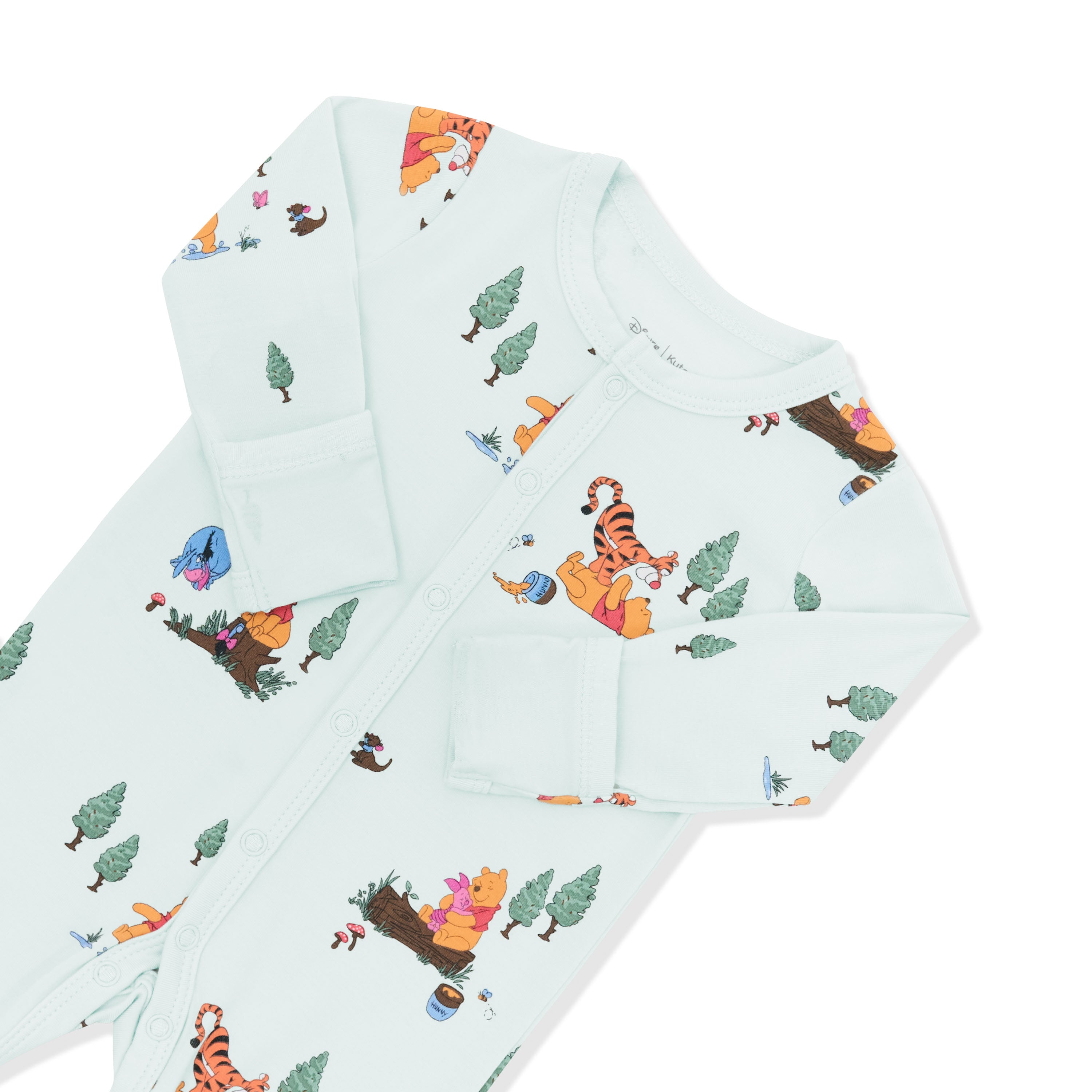 Close up of the snap closure and fold over hand cuffs shown on the Footie in Winnie the Pooh Hundred Acre Wood