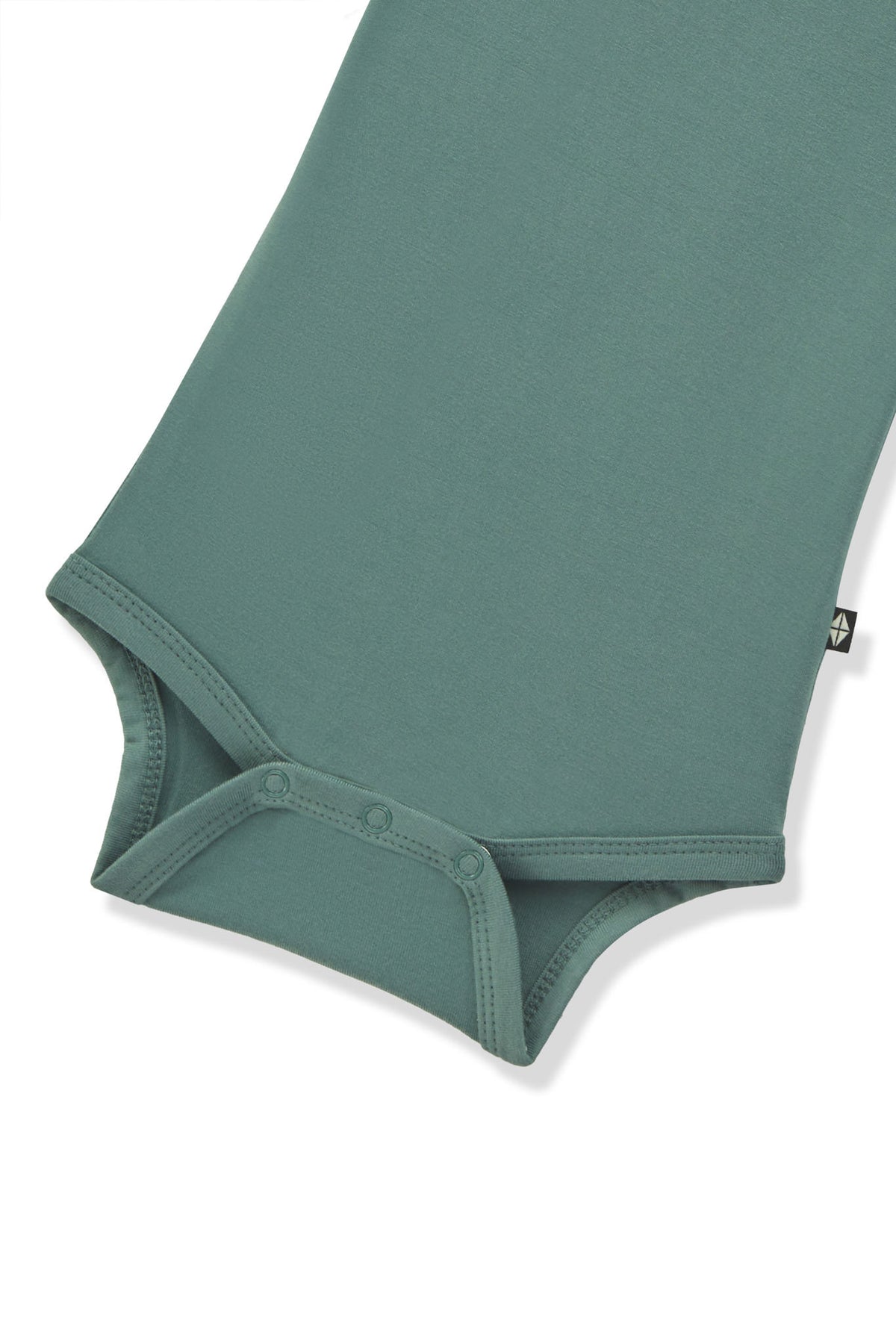 Bottom part of Long Sleeve Bodysuit in Pine with snap buttons on a white background