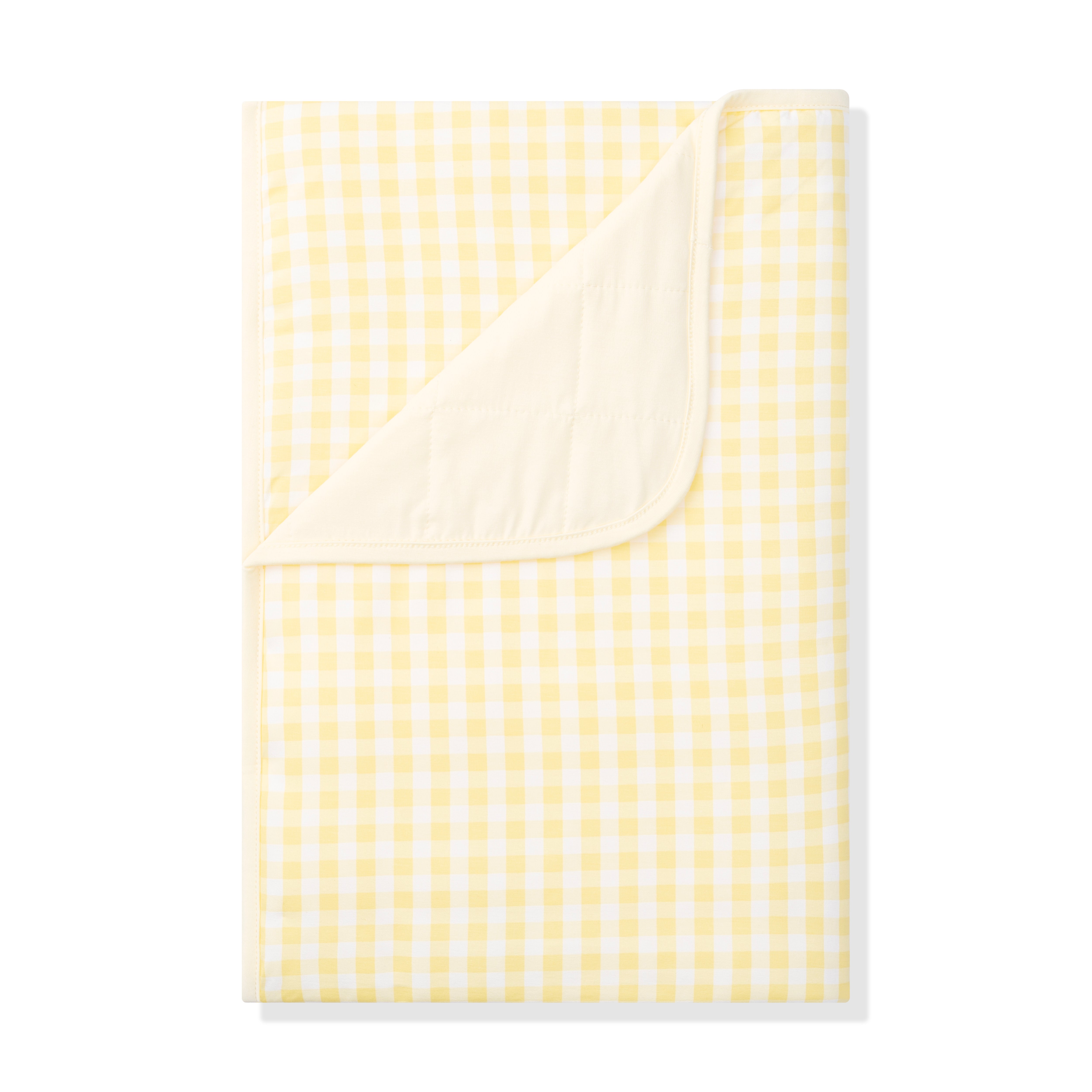 Toddler Blanket in Gingham Chamomile 1.0 with the corner flipped down showing the light yellow backing