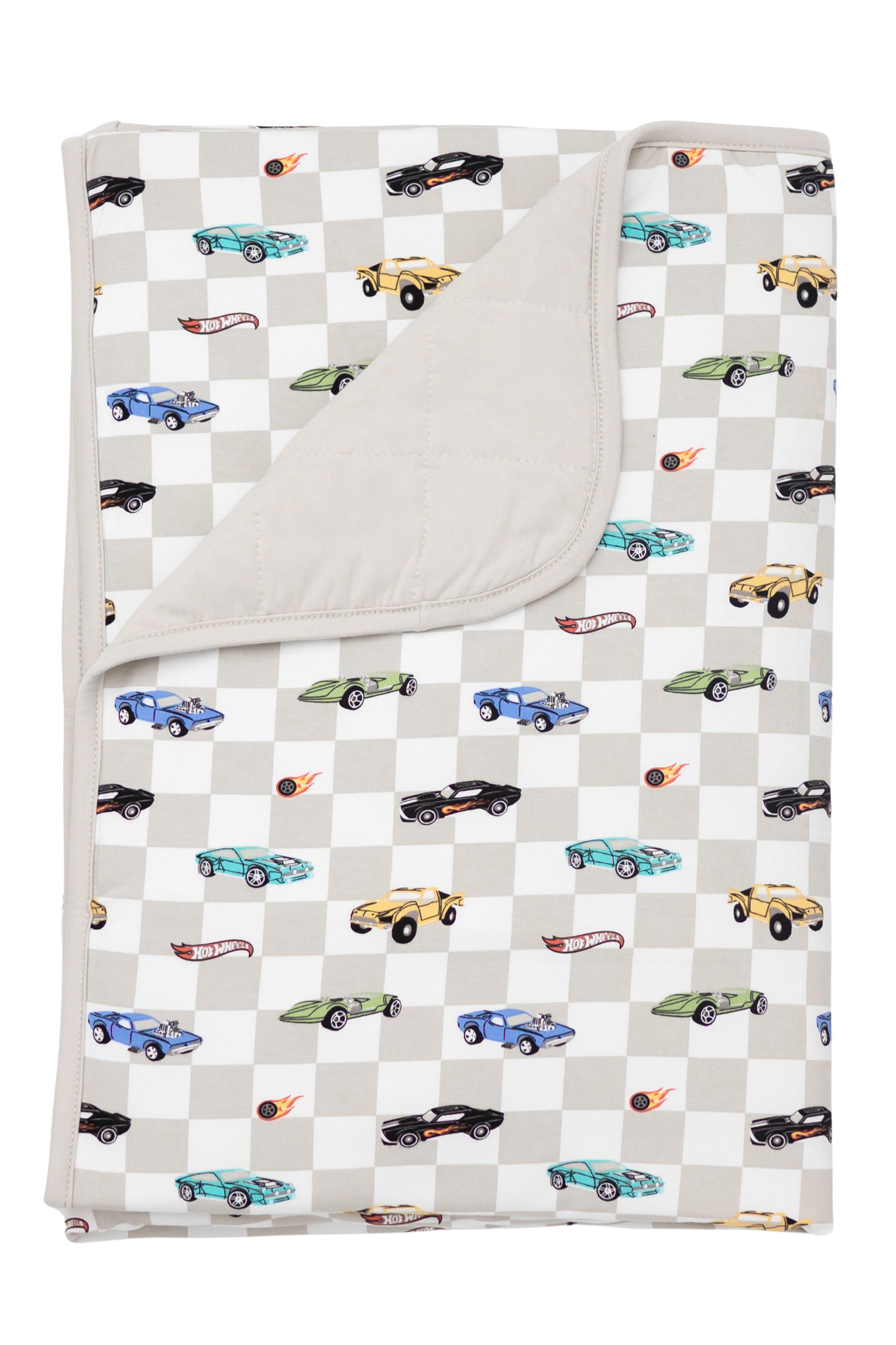 Kyte Baby's Toddler Blanket in Fast and Fierce 1.0 with corner flipped down showing the Oat colored backing