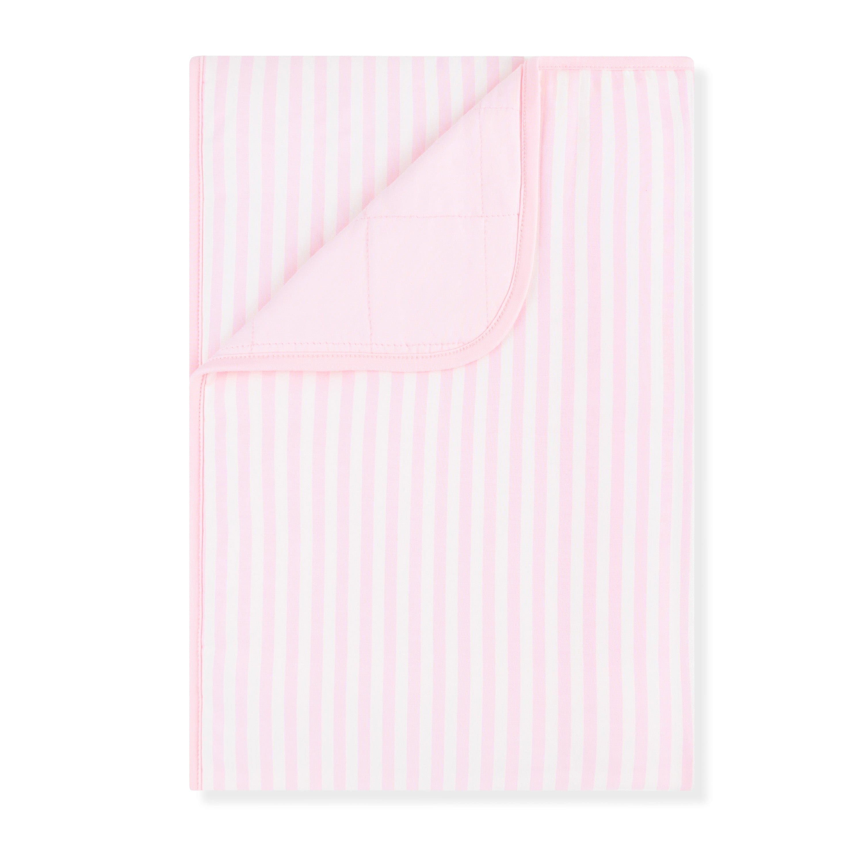 Product photo of the Toddler Blanket in Small Sakura Stripe 1.0 with the corner flipped down showing the light pink backing
