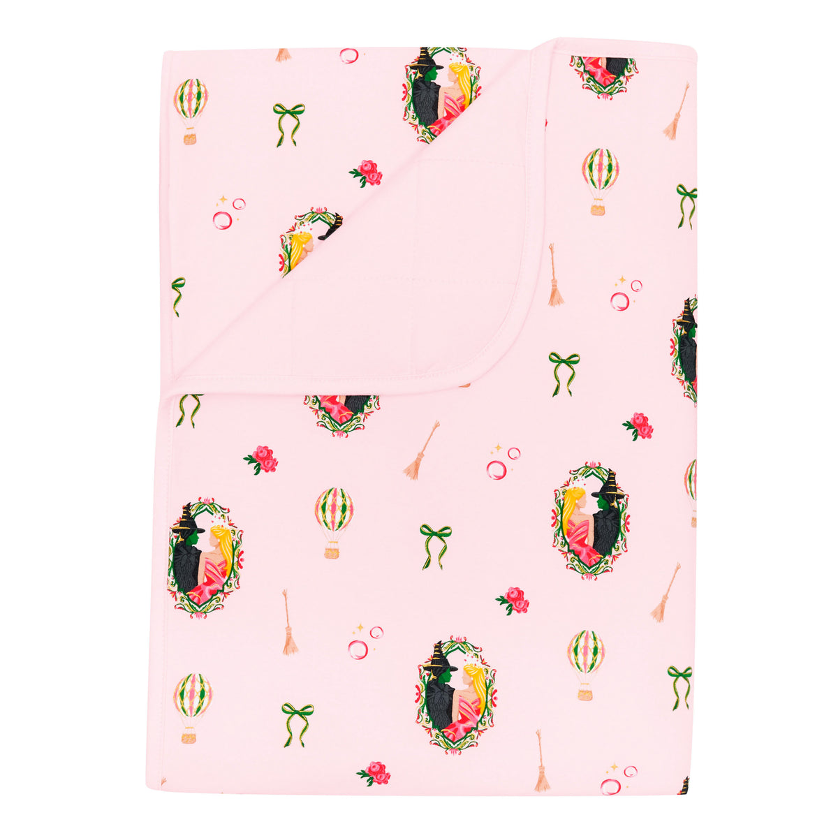 Toddler Blanket in Wicked 1.0 with the corner flipped down showing the light pink backing
