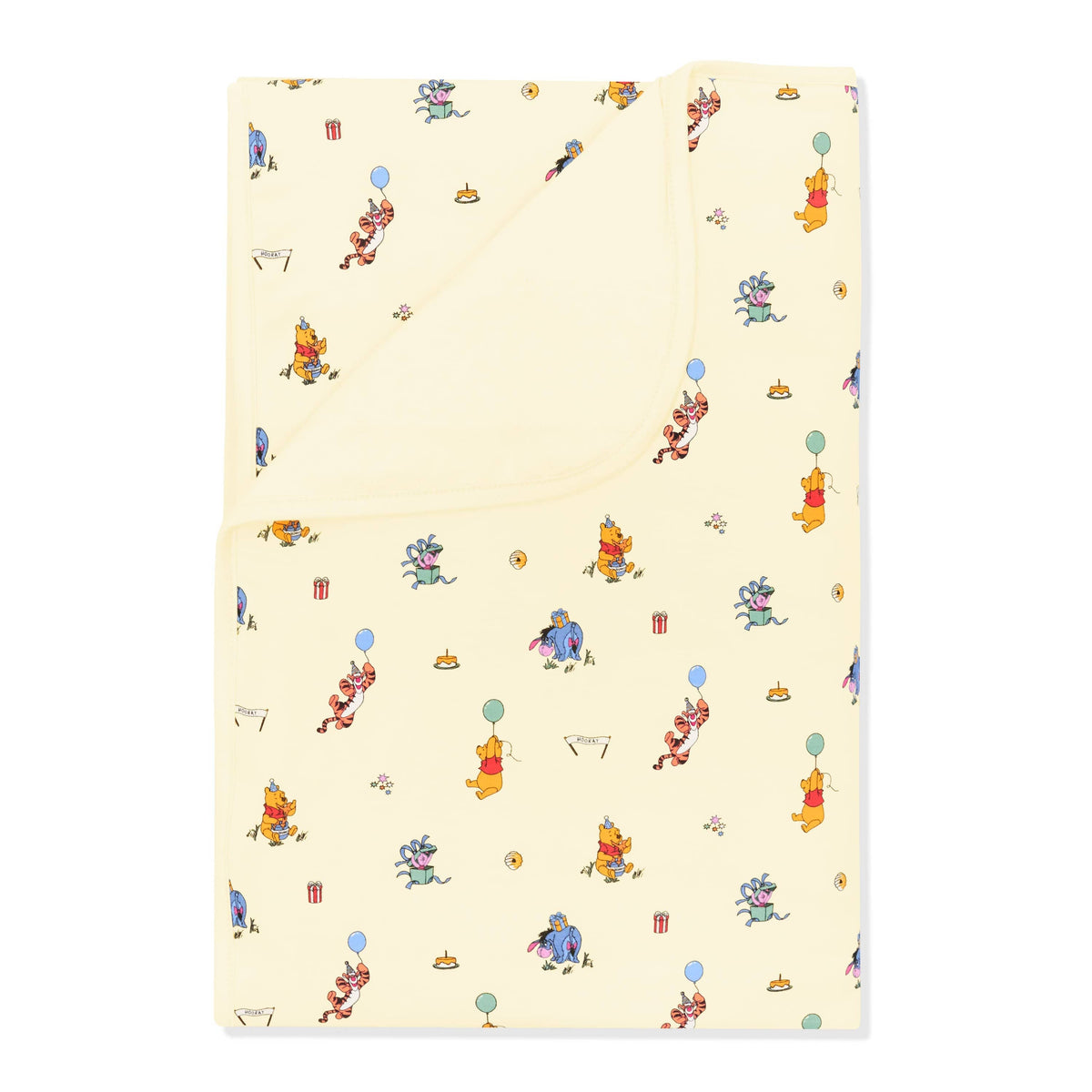 Toddler Blanket in Winnie the Pooh Celebration 1.0 with the corner folded down showing the light yellow backing