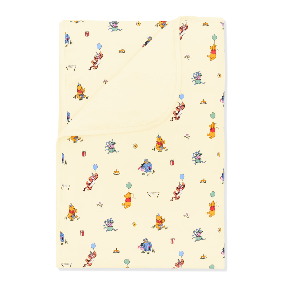 Toddler Blanket in Winnie the Pooh Celebration 1.0 with the corner folded down showing the light yellow backing