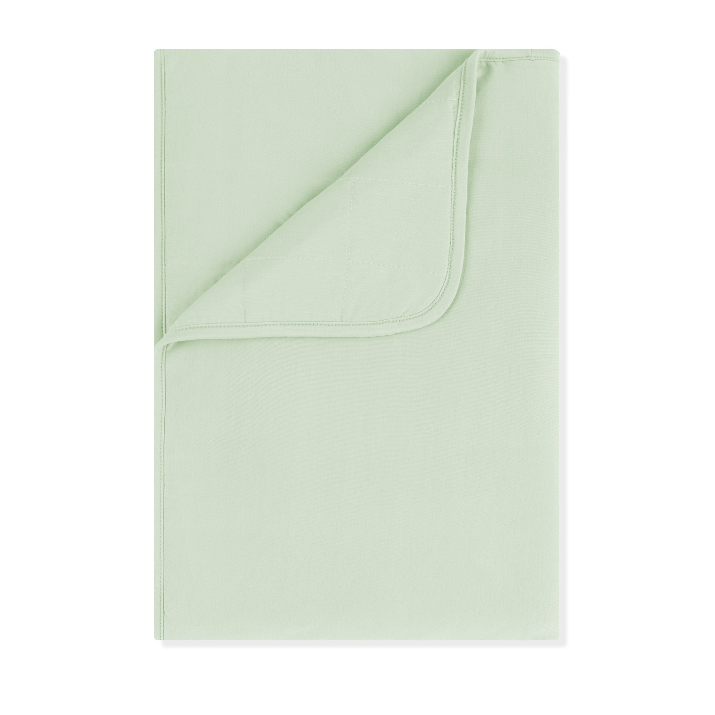 Toddler Blanket in Basil 1.0 shown with the corner flipped down showing the quilted backing