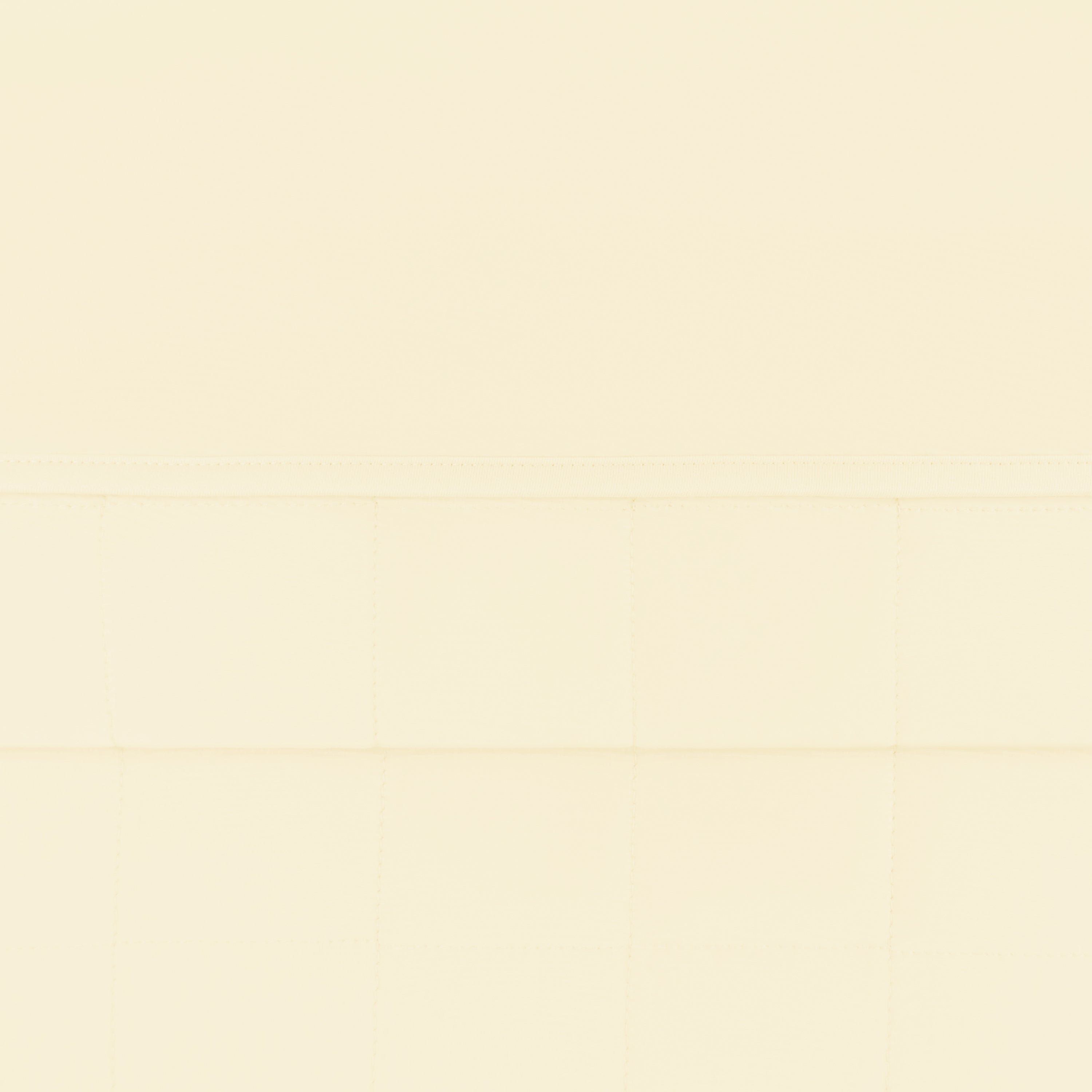 Close up of the quilted bottom and smooth top layer of the Toddler Blanket in Chamomile 1.0