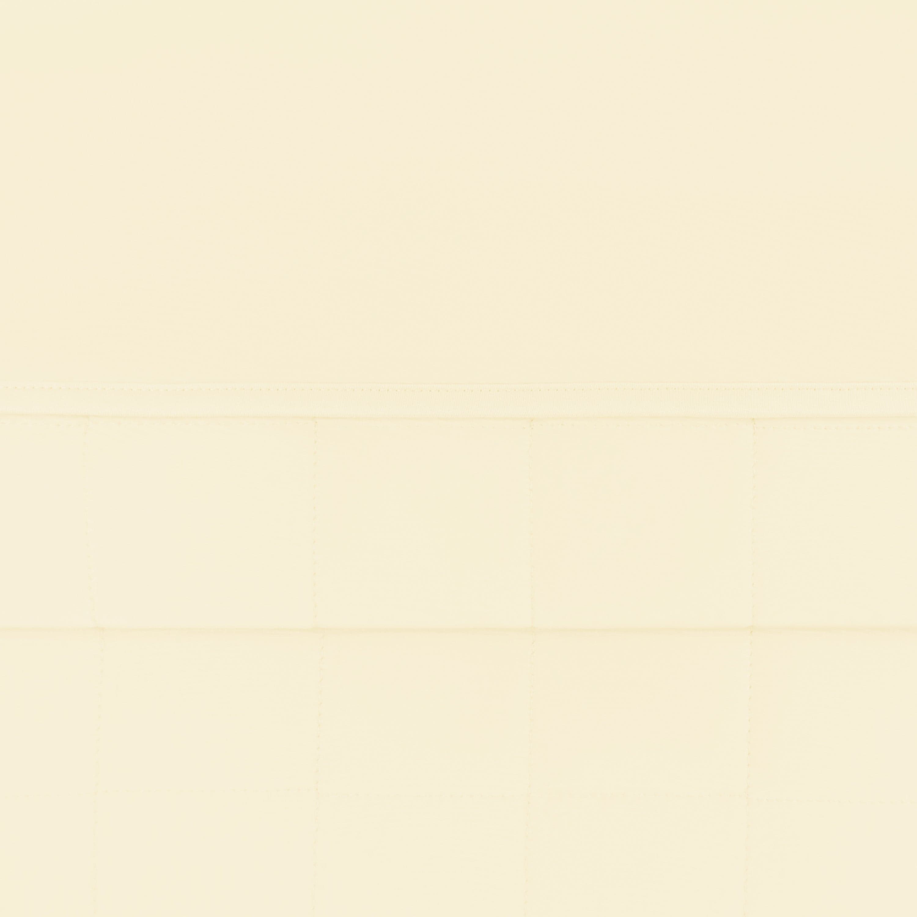 Close up of the quilted bottom and smooth top layer of the Toddler Blanket in Chamomile 1.0