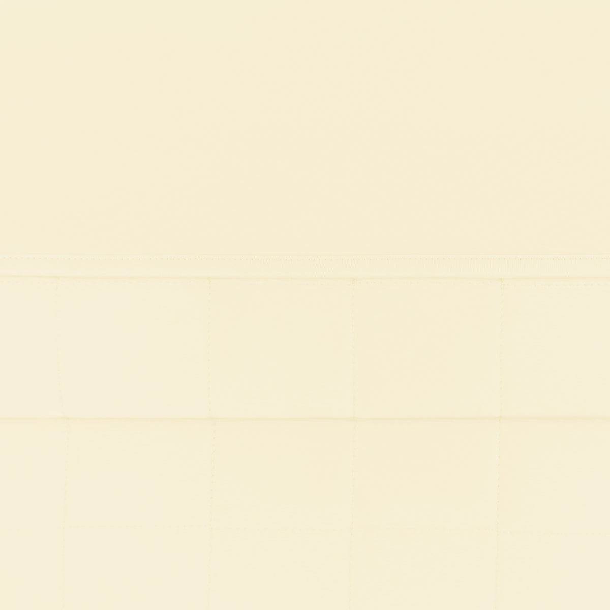 Close up of the quilted bottom and smooth top layer of the Toddler Blanket in Chamomile 1.0