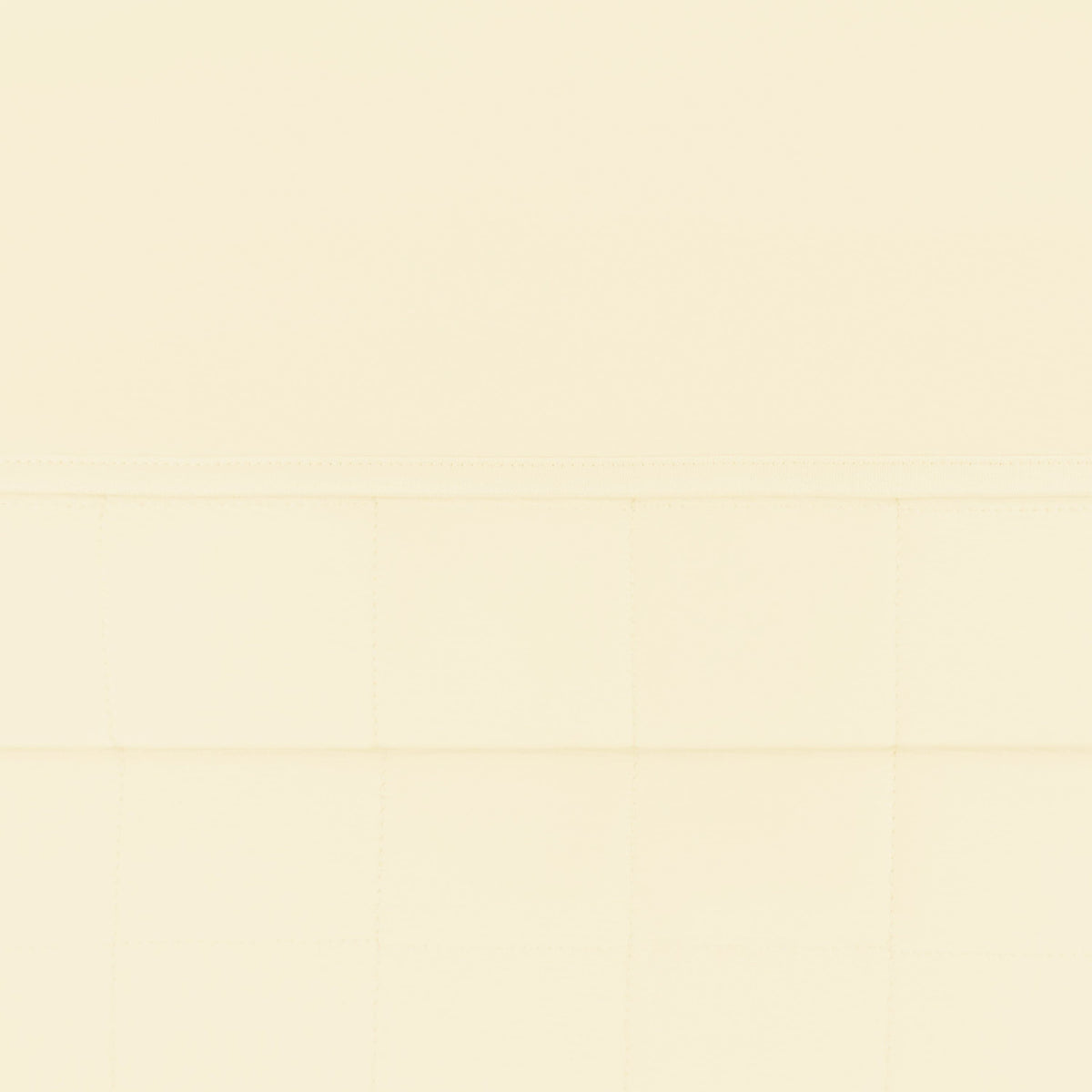 Close up of the quilted bottom and smooth top layer of the Toddler Blanket in Chamomile 1.0