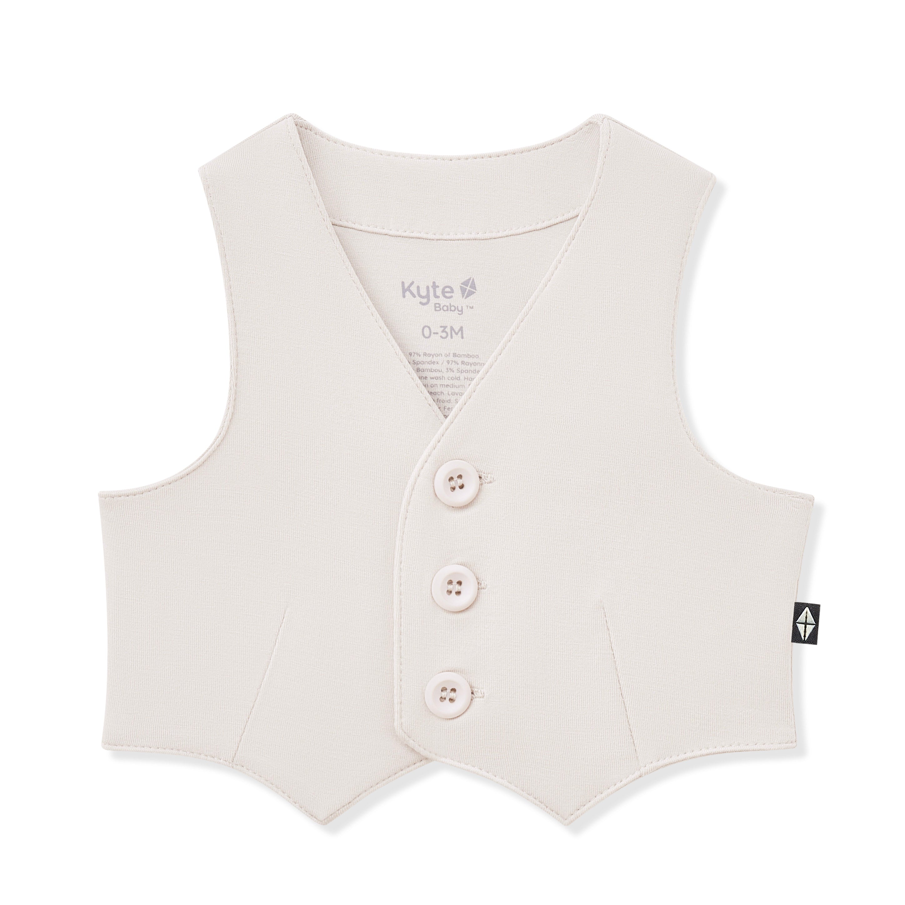 Cream toddler vest with buttons on a white background