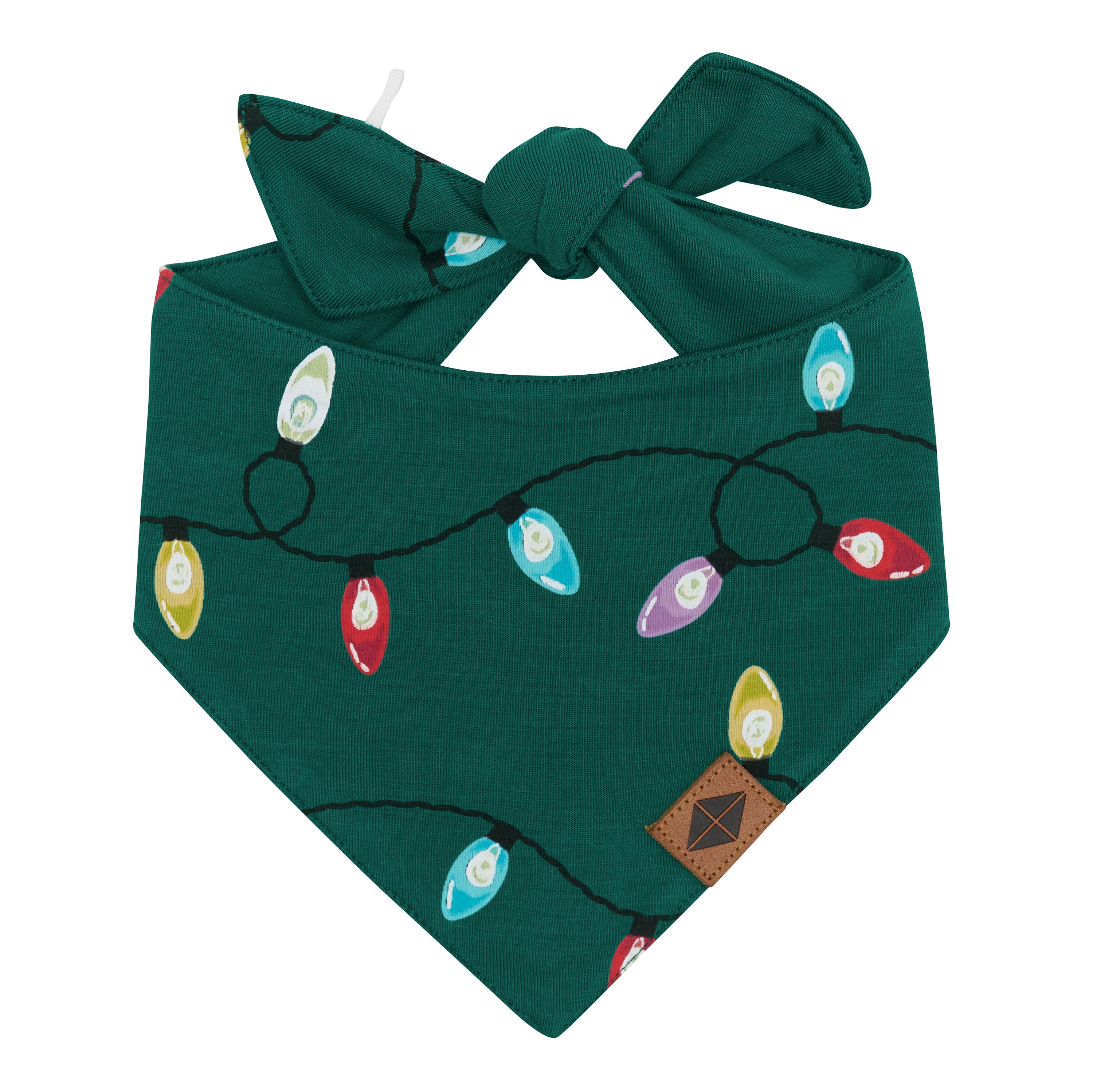 Front of the Dog Bandana in Merry and Bright showing the vegan leather Kyte Baby logo tag and the tie closure