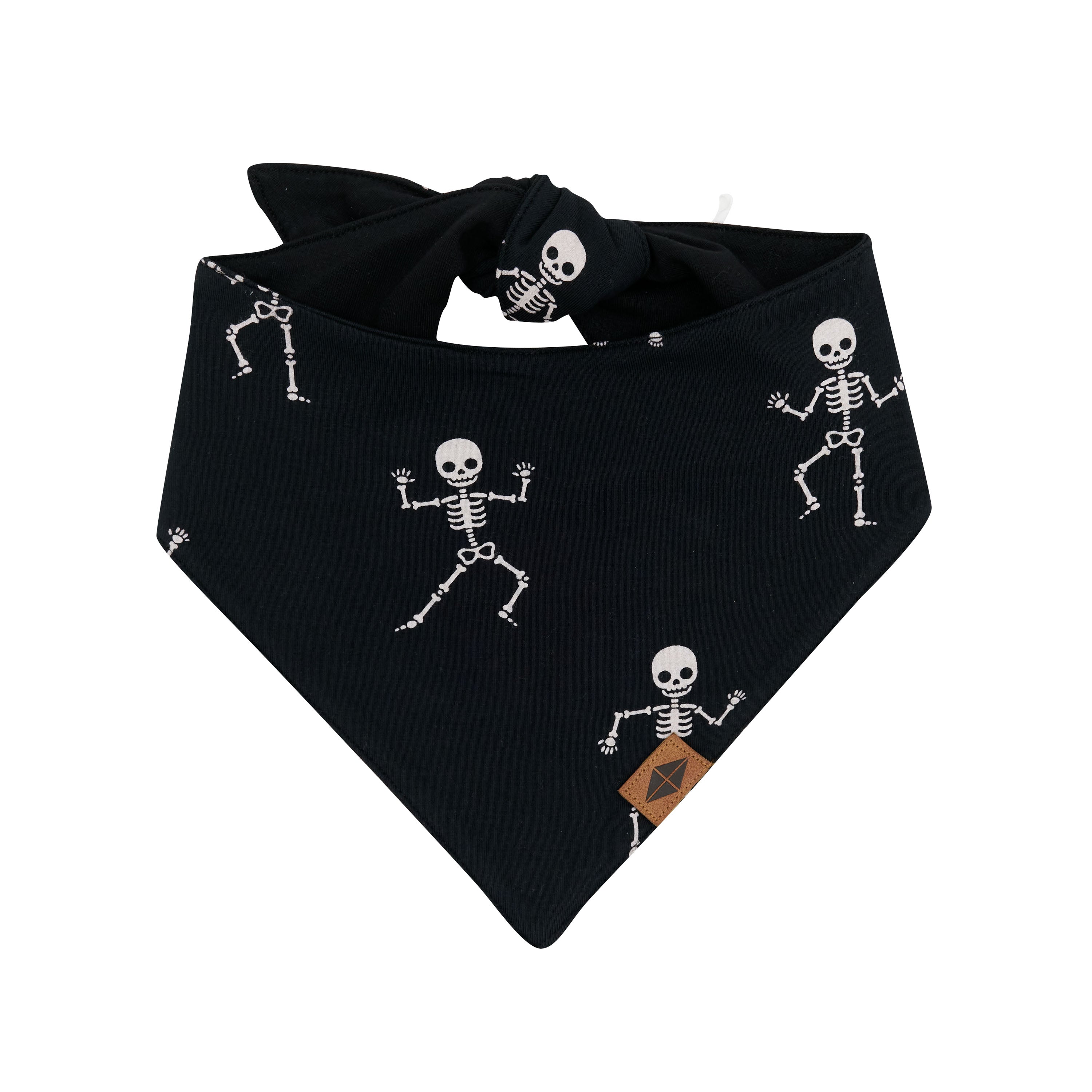 The front of the Dog Bandana in Skeleton with the vegan leather Kyte Baby Logo visible
