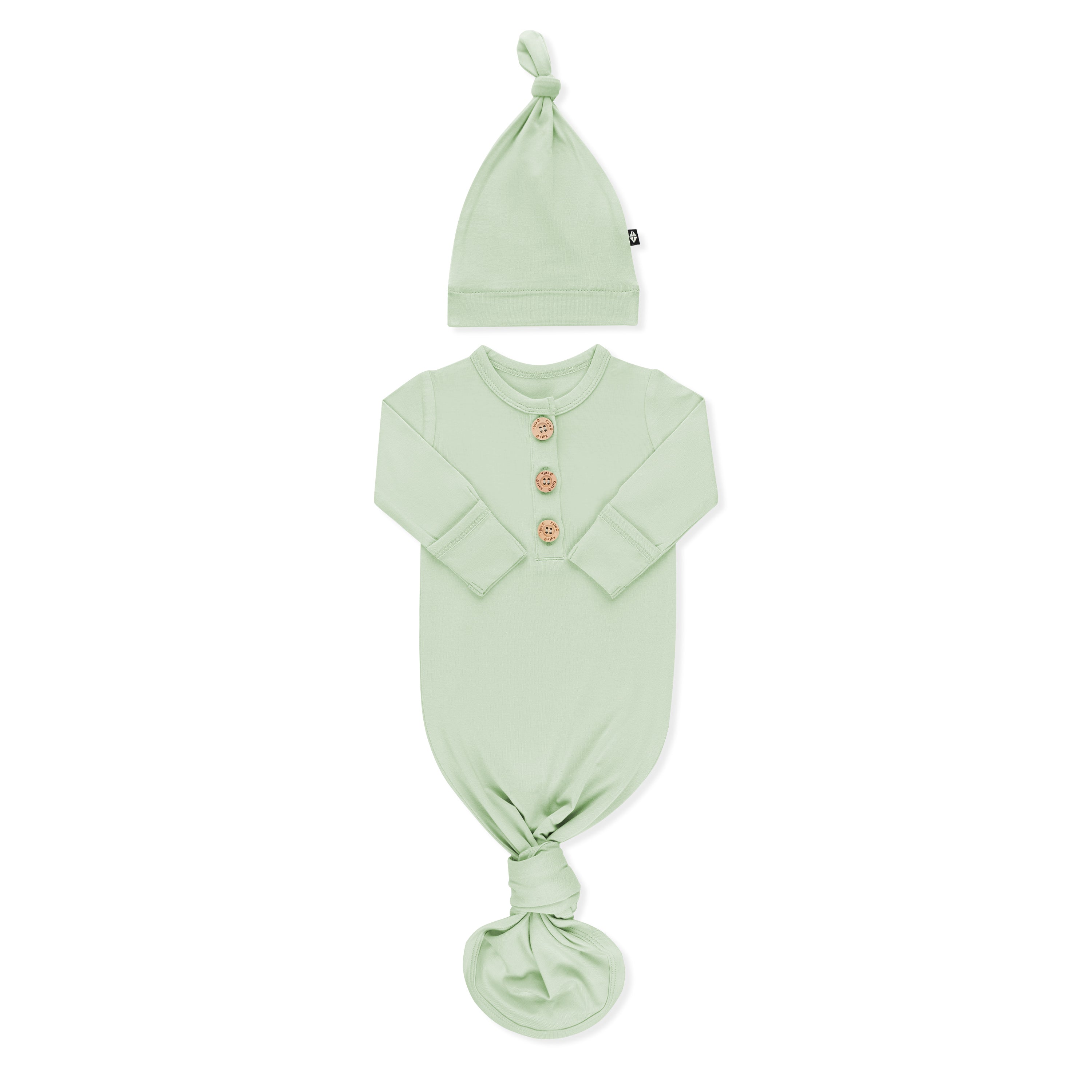 Product photo of the Knotted Gown with Hat Set in Basil with the arms folded inwards