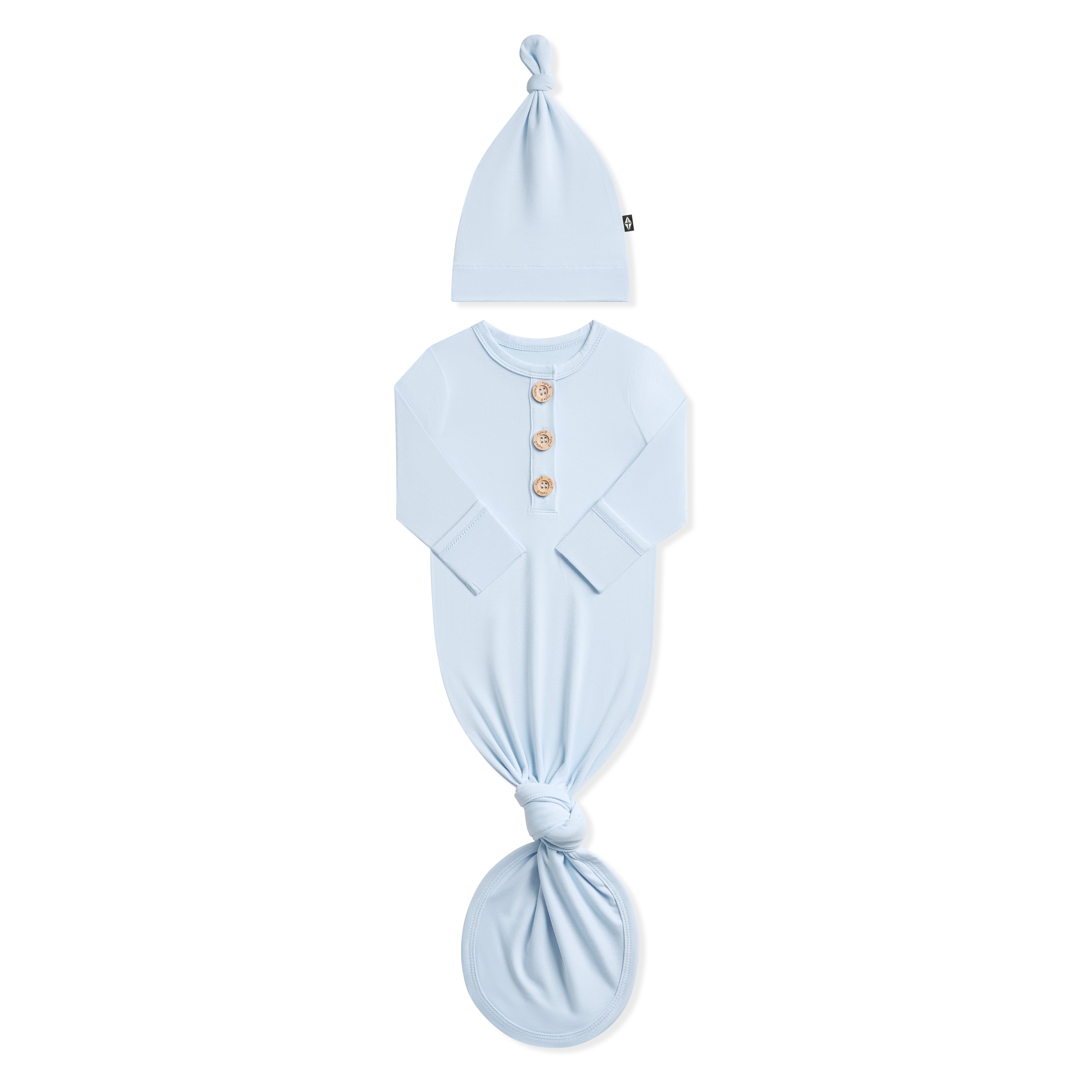 Product photo of the Knotted Gown with Hat Set in Breeze shown with the arms folded in