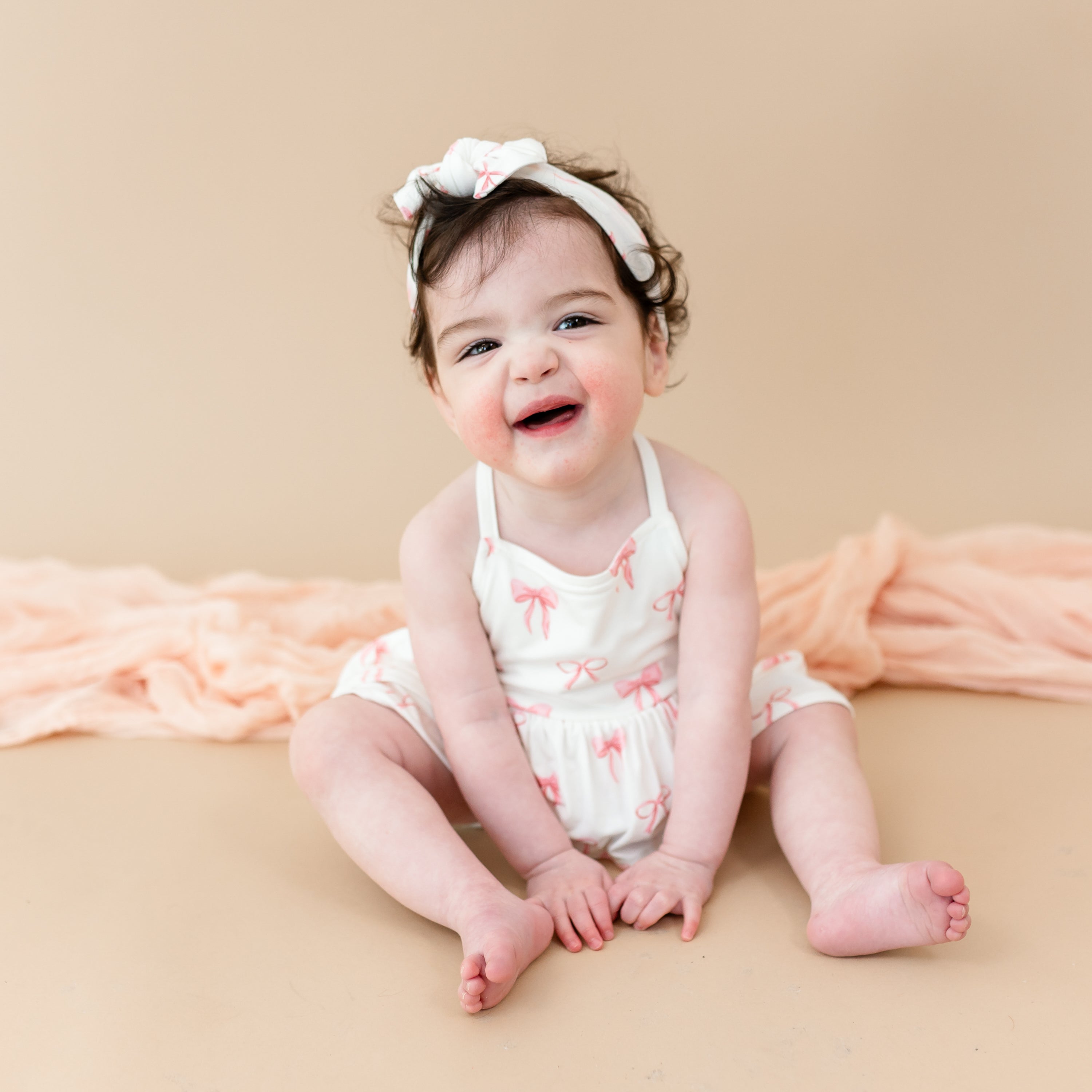 Young toddler wearing Spaghetti Strap Ruffle Romper in Bow