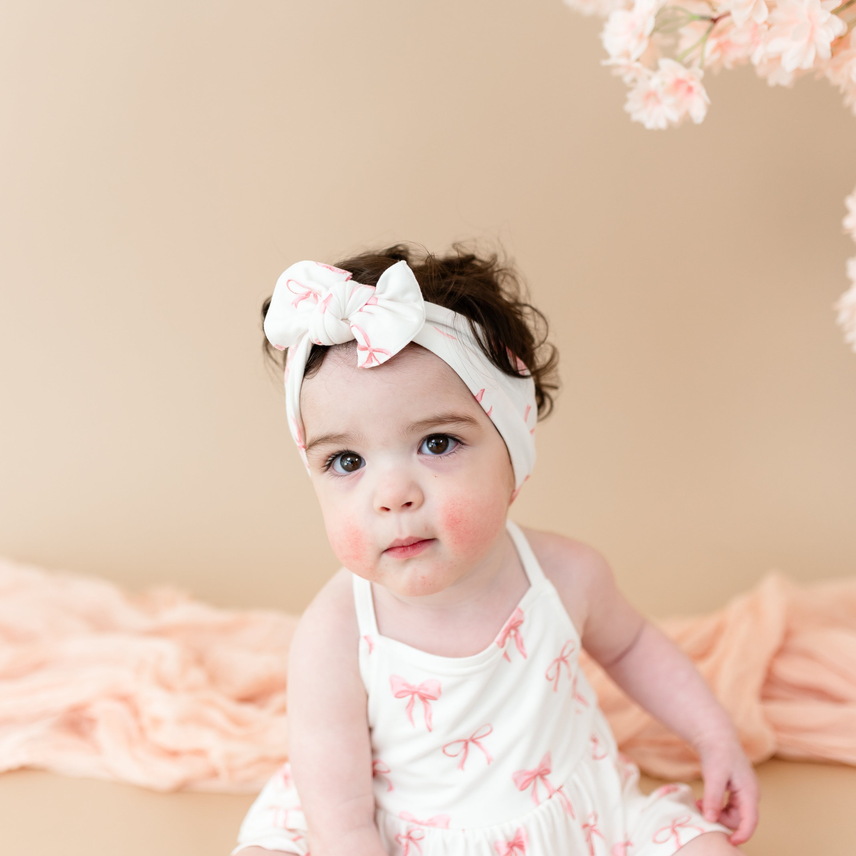 Young toddler wearing Spaghetti Strap Ruffle Romper in Bow close up