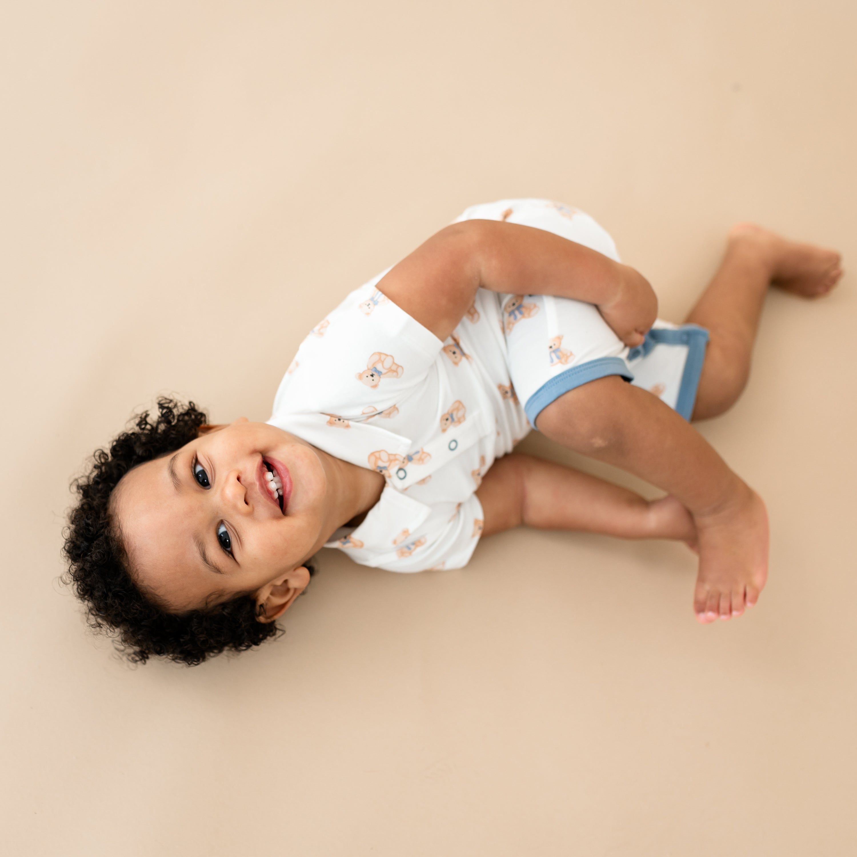 Toddler smiling wearing Polo Shortall in Teddy Bear