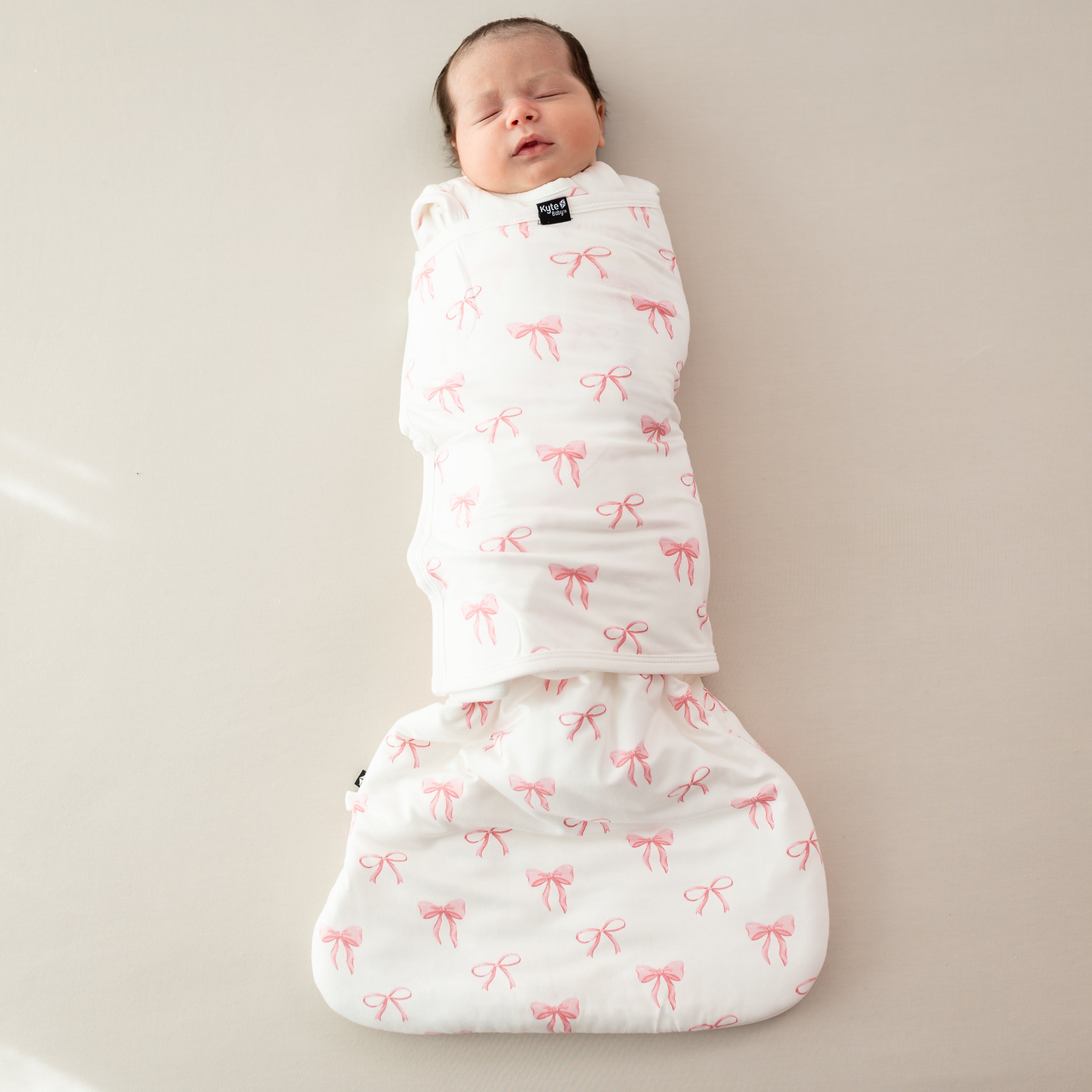 Baby asleep wearing Sleep Bag Swaddler in Bow 1.0