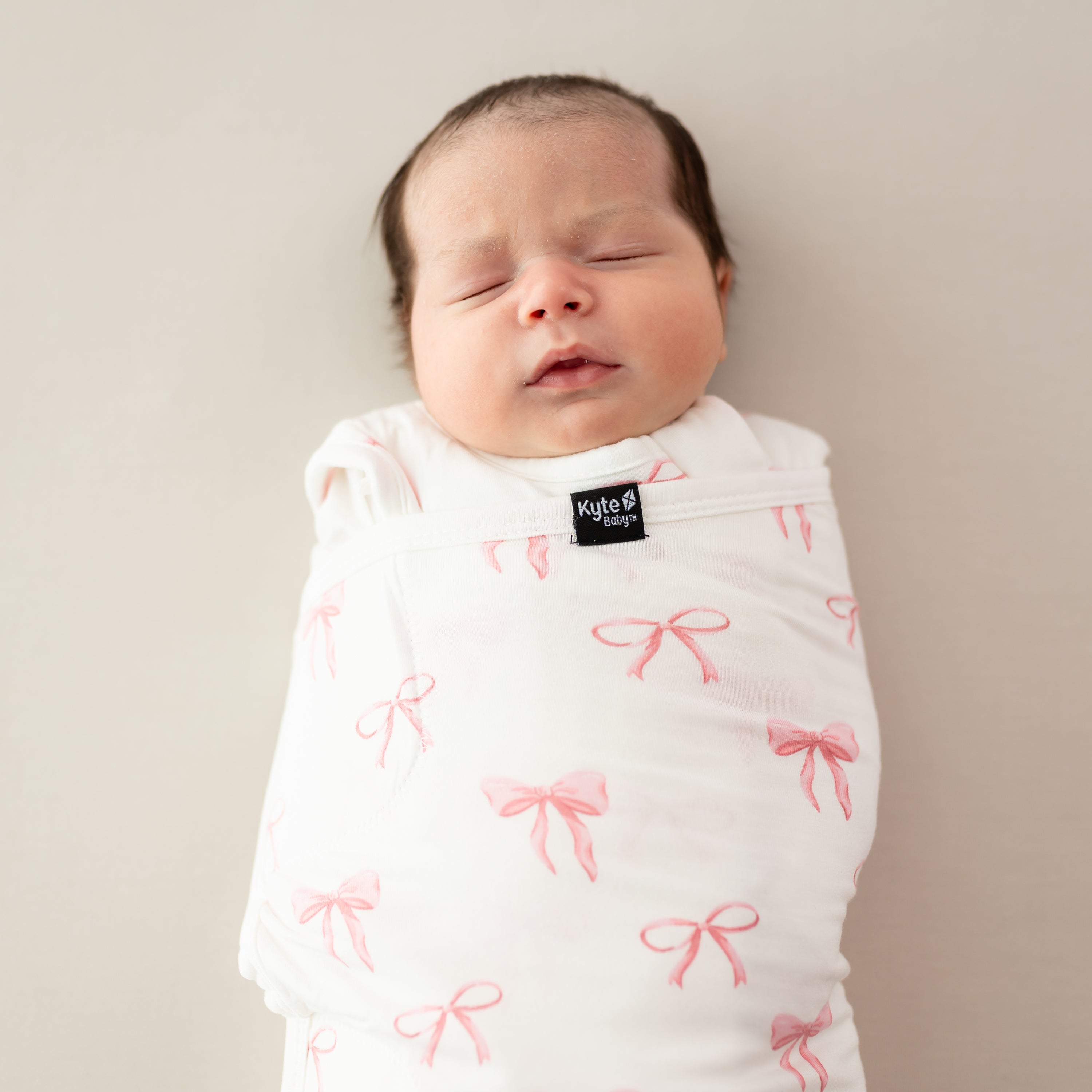 Close up on baby wearing Sleep Bag Swaddler in Bow