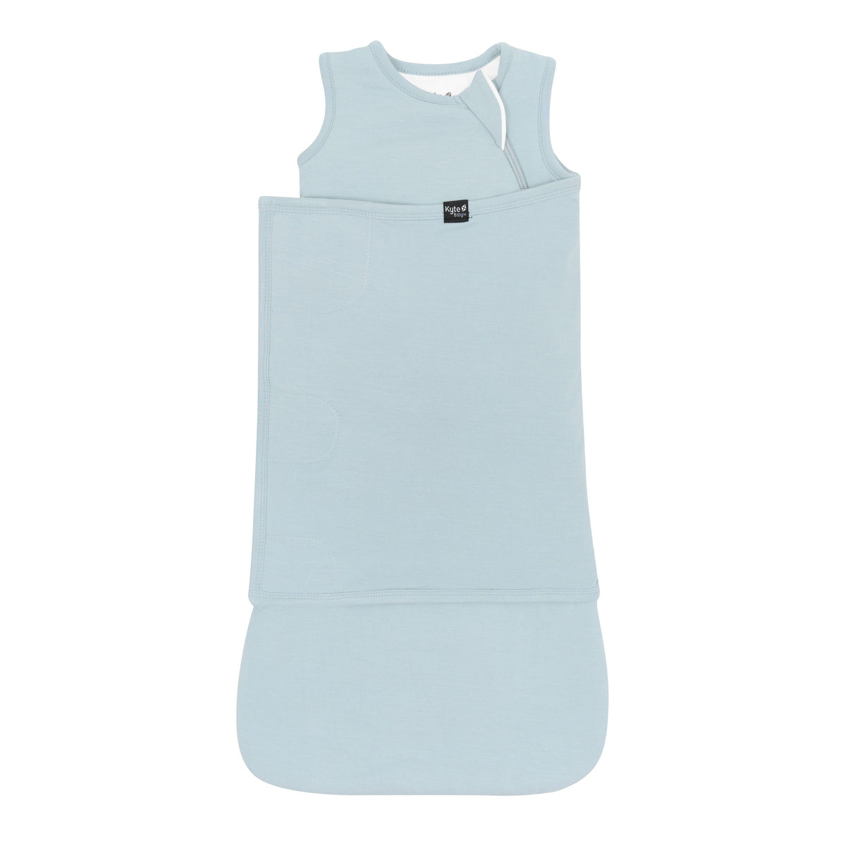 Sleep Bag Swaddler in Fog 1.0 shown swaddled with the Black Kyte Baby logo visible