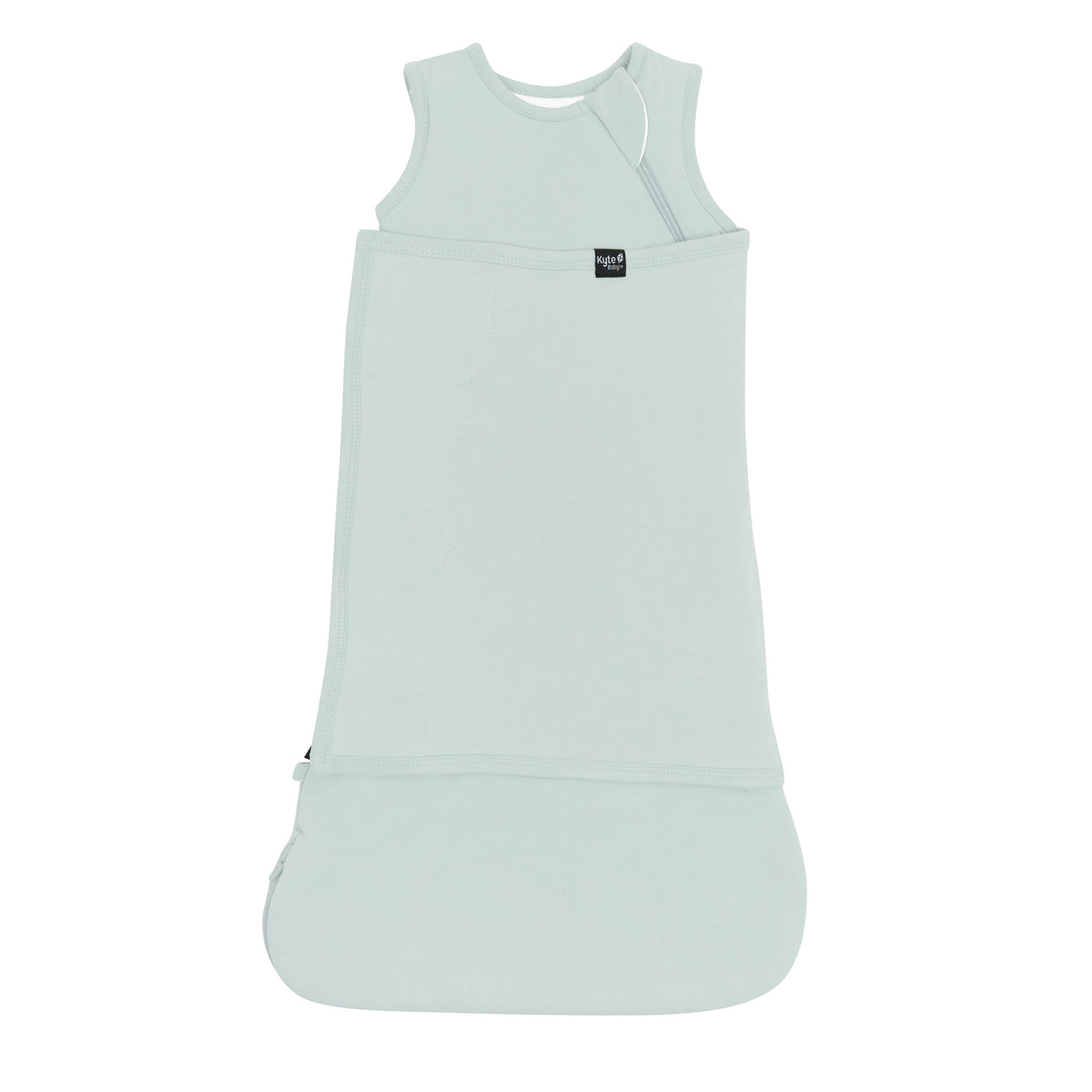 Sleep Bag Swaddler in Sage 1.0 shown swaddled with the Black Kyte Baby logo visible