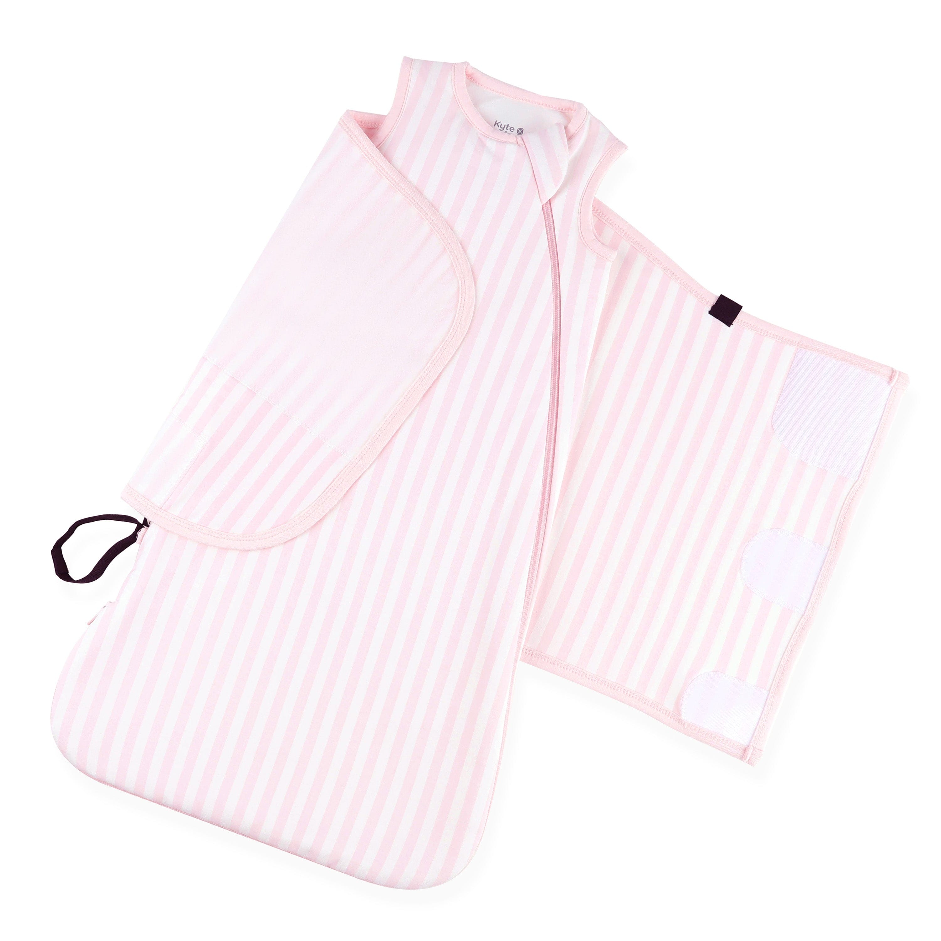 Sleep bag and adjustable velcro wrap shown on an unswaddled Sleep Bag Swaddler in Small Sakura Stripe 1.0