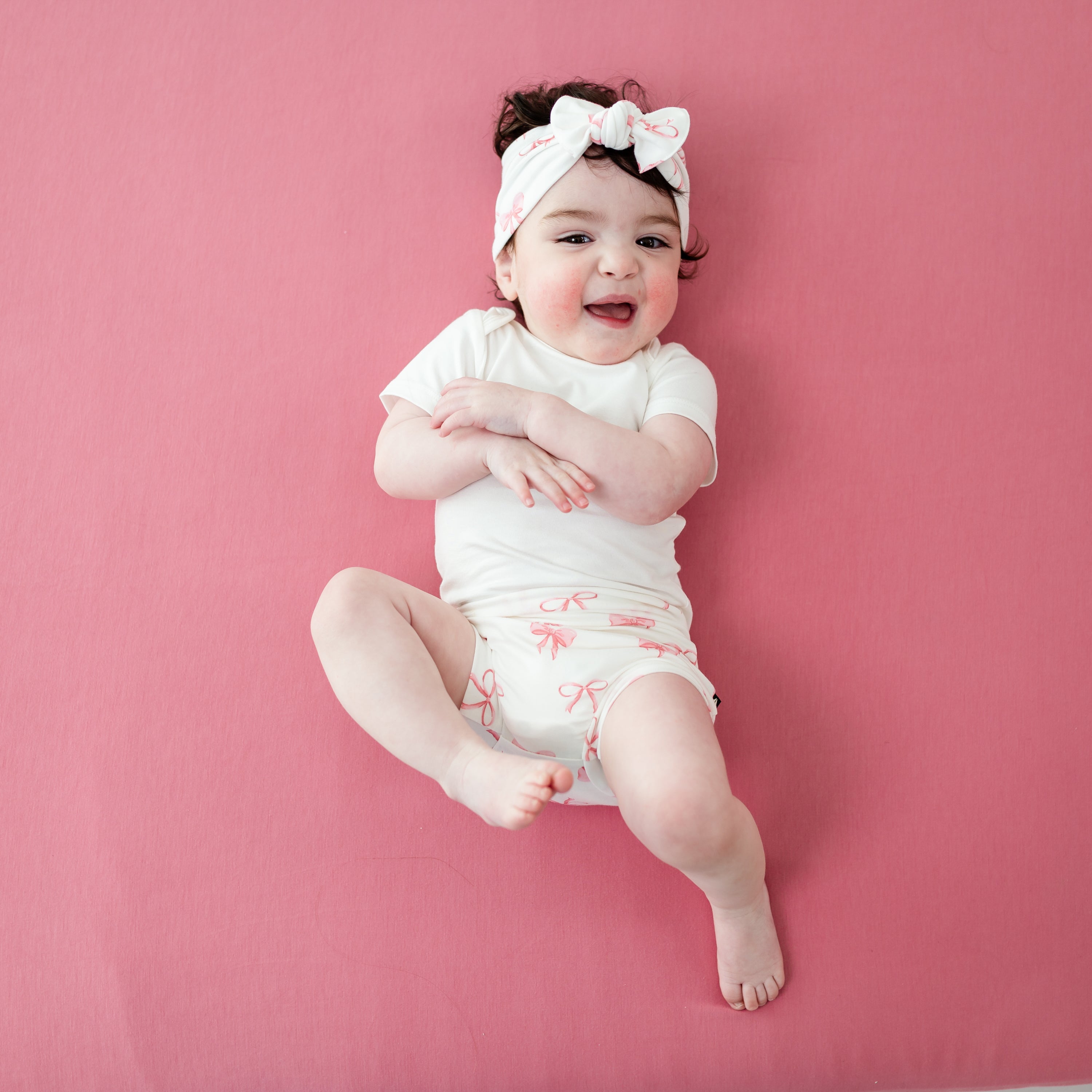 Young toddler modeling Bummies in Bow with matching bow and short sleeve cloud bodysuit