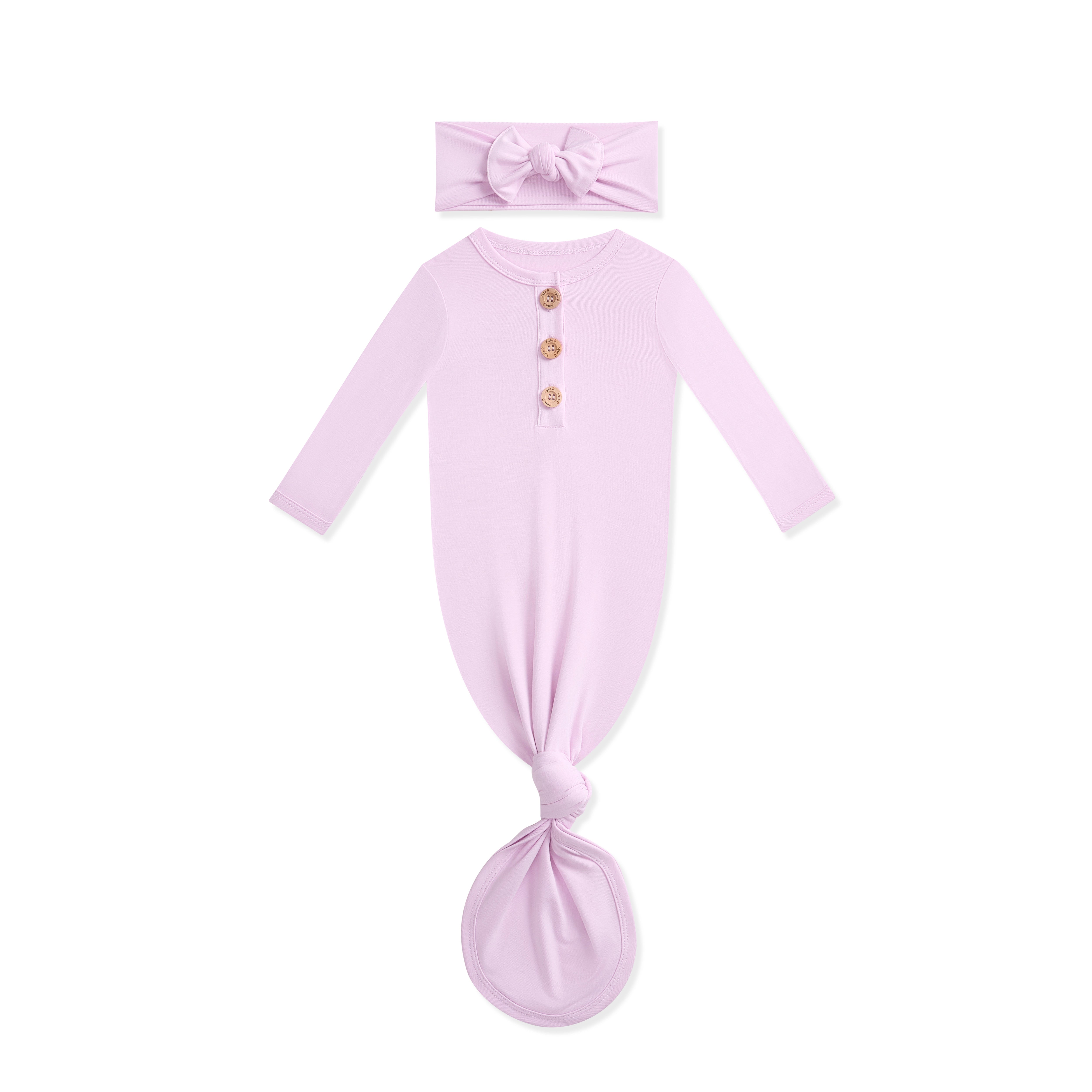 Lavender baby knotted gown with wooden buttons and matching headband on a white background