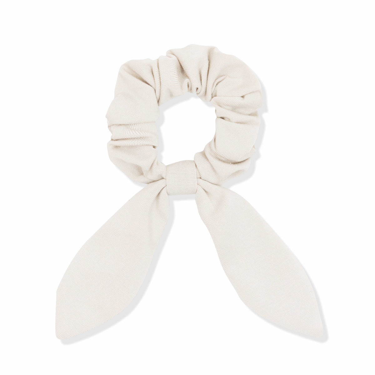 Beige scrunchie with bow on a white background
